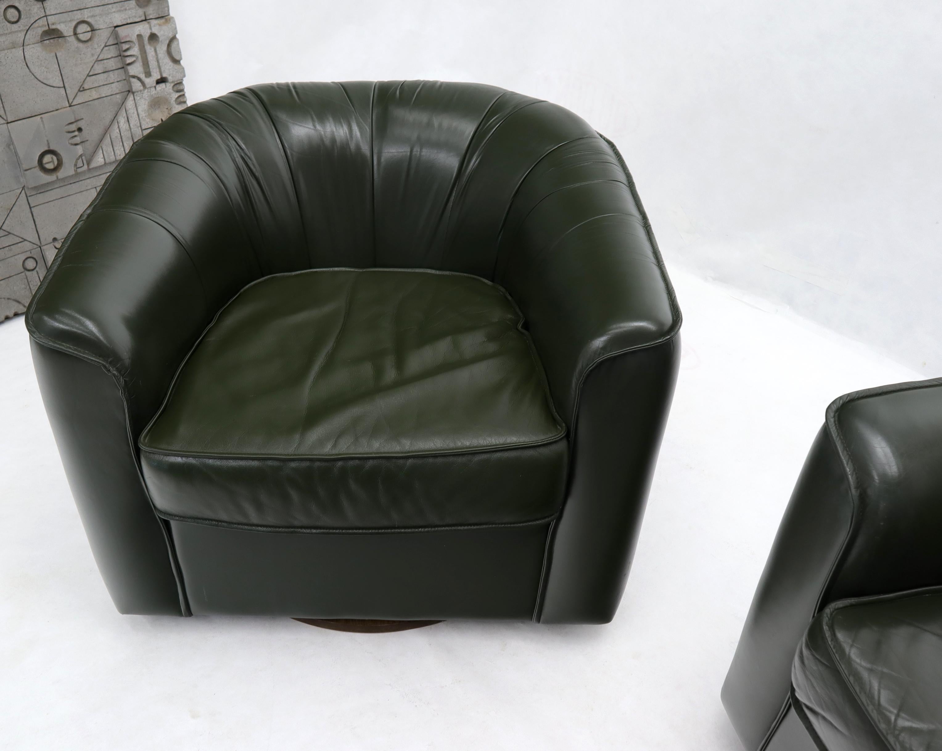 Mid-Century Modern Pair of Swivel Dark Olive Green Leather Upholstery Lounge Chairs with Ottoman