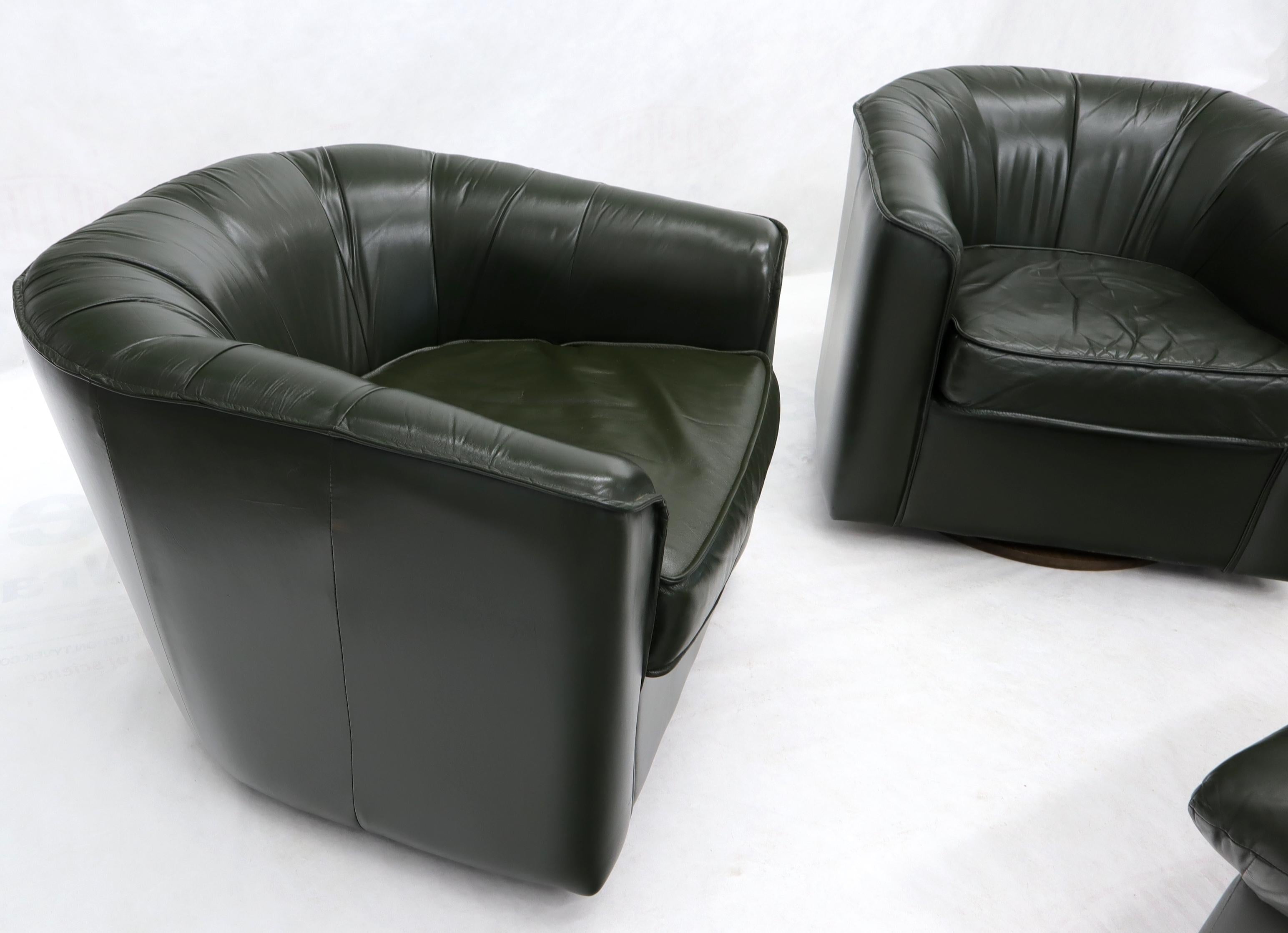 American Pair of Swivel Dark Olive Green Leather Upholstery Lounge Chairs with Ottoman