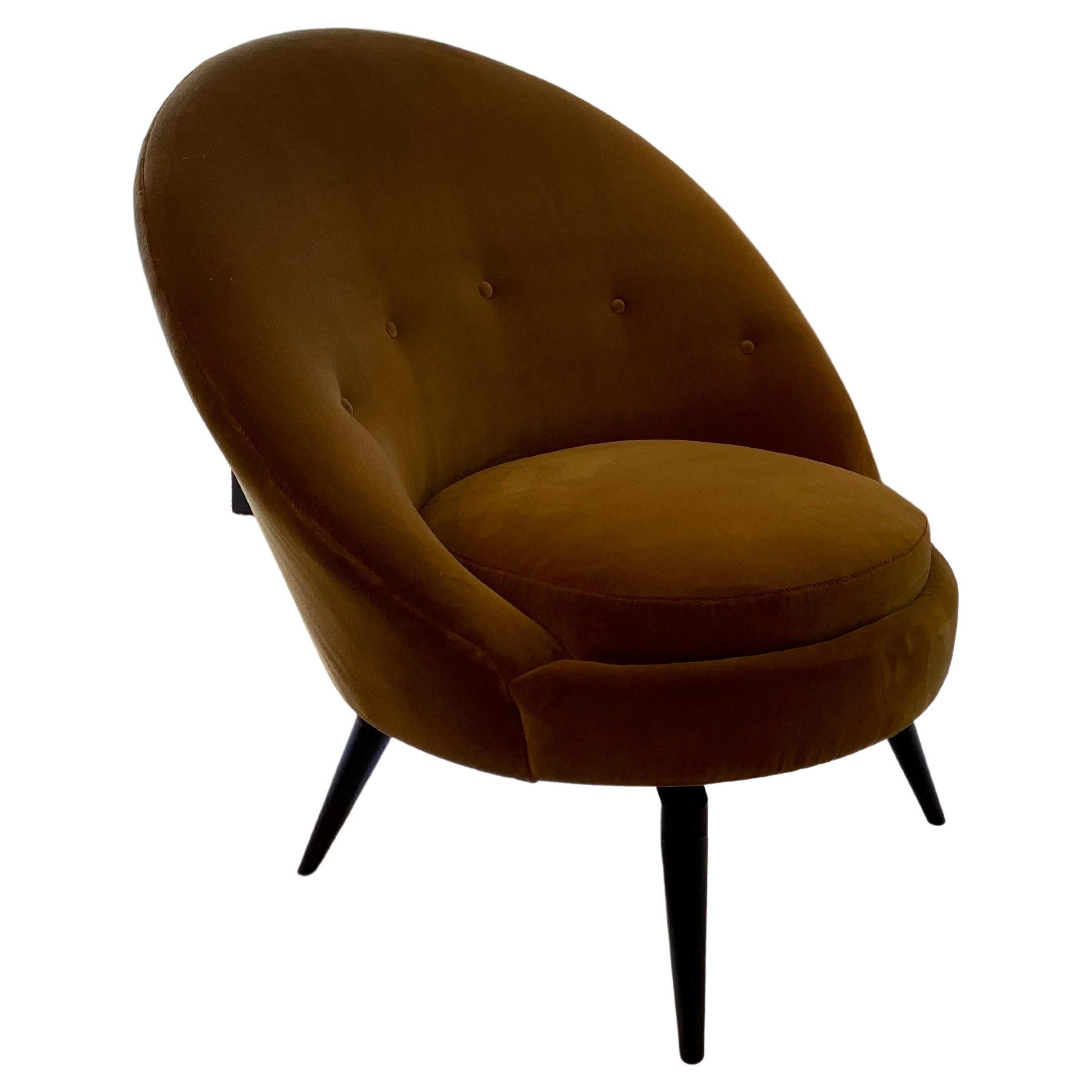 Swivel Egg chairs in the French Midcentury style. This sophisticated chair is upholstered in luxurious heavy weight, backed Mustard gold faux Mohair. This super stylish and versatile example is as comfortable as it looks and is painstakingly