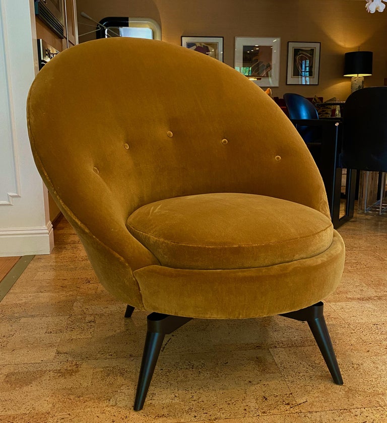 Pair of Swivel egg chairs in the French Midcentury style. This sophisticated chair is upholstered in luxurious heavy weight, backed Mustard gold faux Mohair. This super stylish and versatile example is as comfortable as it looks and is painstakingly