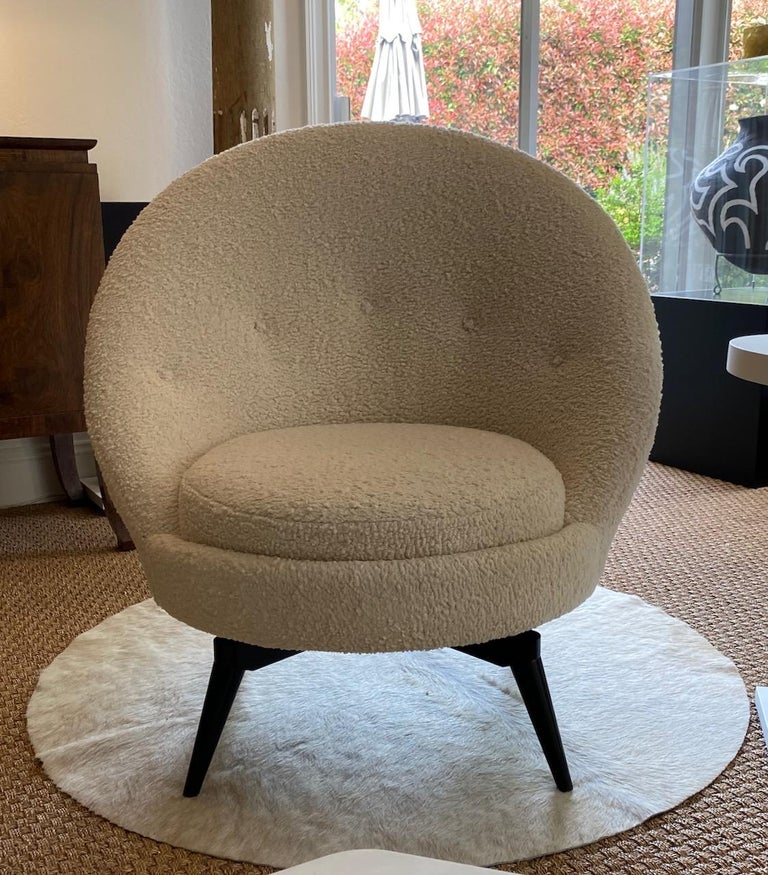Swivel egg chair in the French mid-century style. This sophisticated chair is upholstered in a luxurious heavy-weight Bouclé. This super stylish and versatile example is as comfortable as it looks and is painstakingly patterned with a hardwood