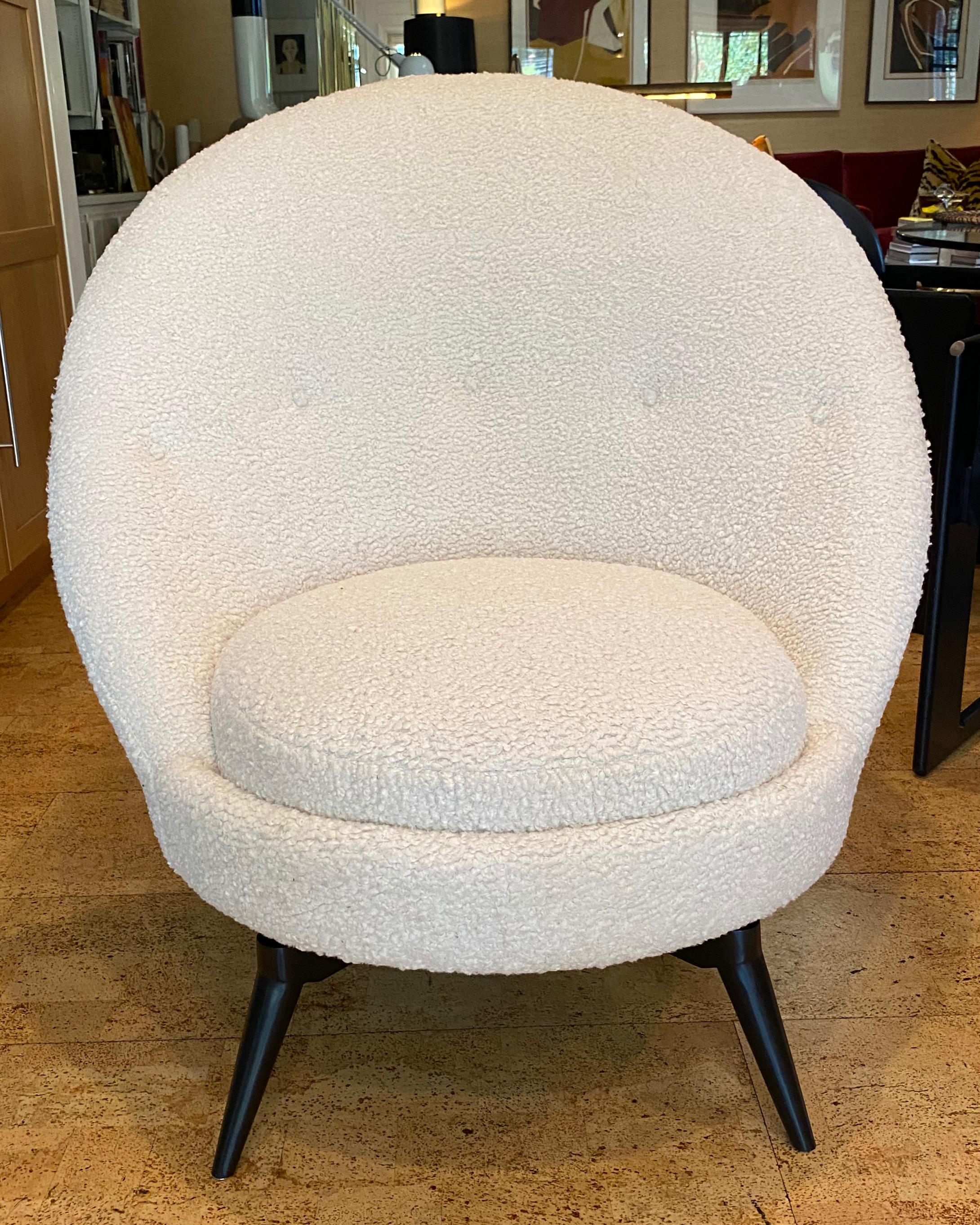 Swivel egg chair in the French midcentury style. This sophisticated chair is upholstered in a luxurious heavy-weight Bouclé. This super stylish and versatile example is as comfortable as it looks and is painstakingly patterned with a hardwood frame,
