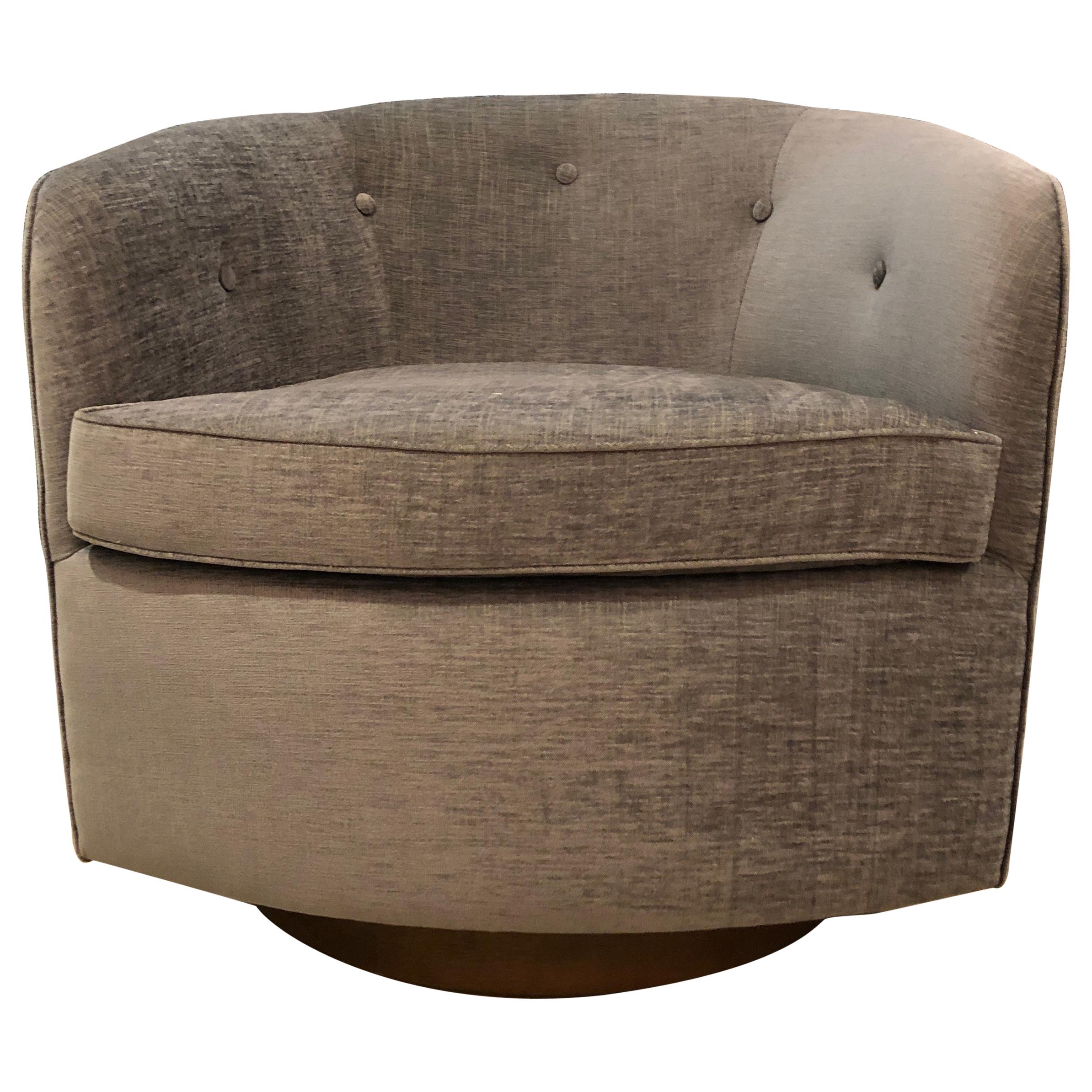 Pair of button backed lounge chairs shown in Saroma Plains chenille fabric (bluebell) on walnut swivel base. Available as shown (in stock) or available COM. Each chair requires 6 yards of fabric.