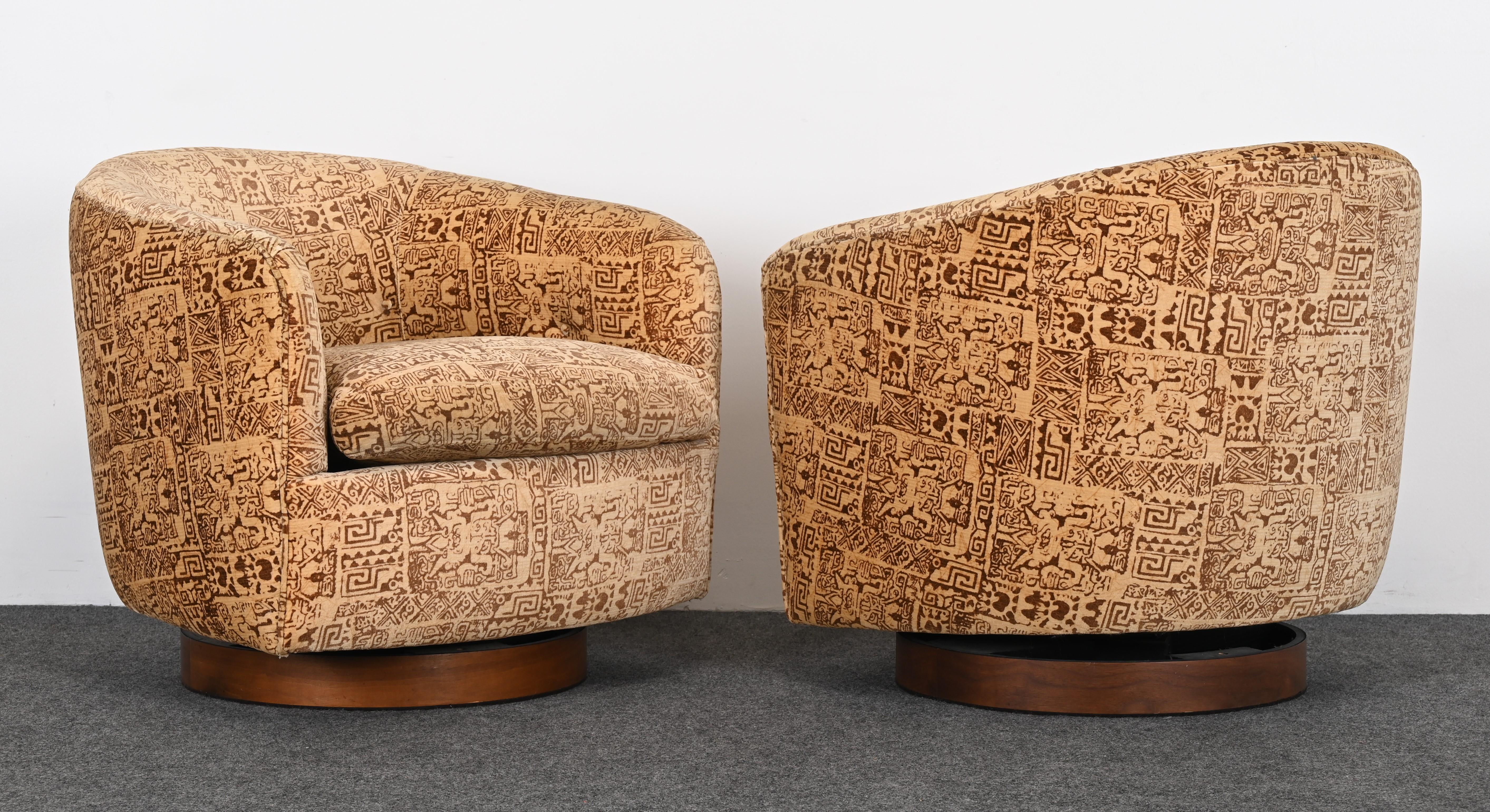 A pair of luxurious plush velvet chairs by Milo Baughman for Thayer Coggin, 1979. The batik fabric is original and has some minor fading. The overall look of the chairs is very pleasing and ready to place. Both chairs rock and swivel. The original