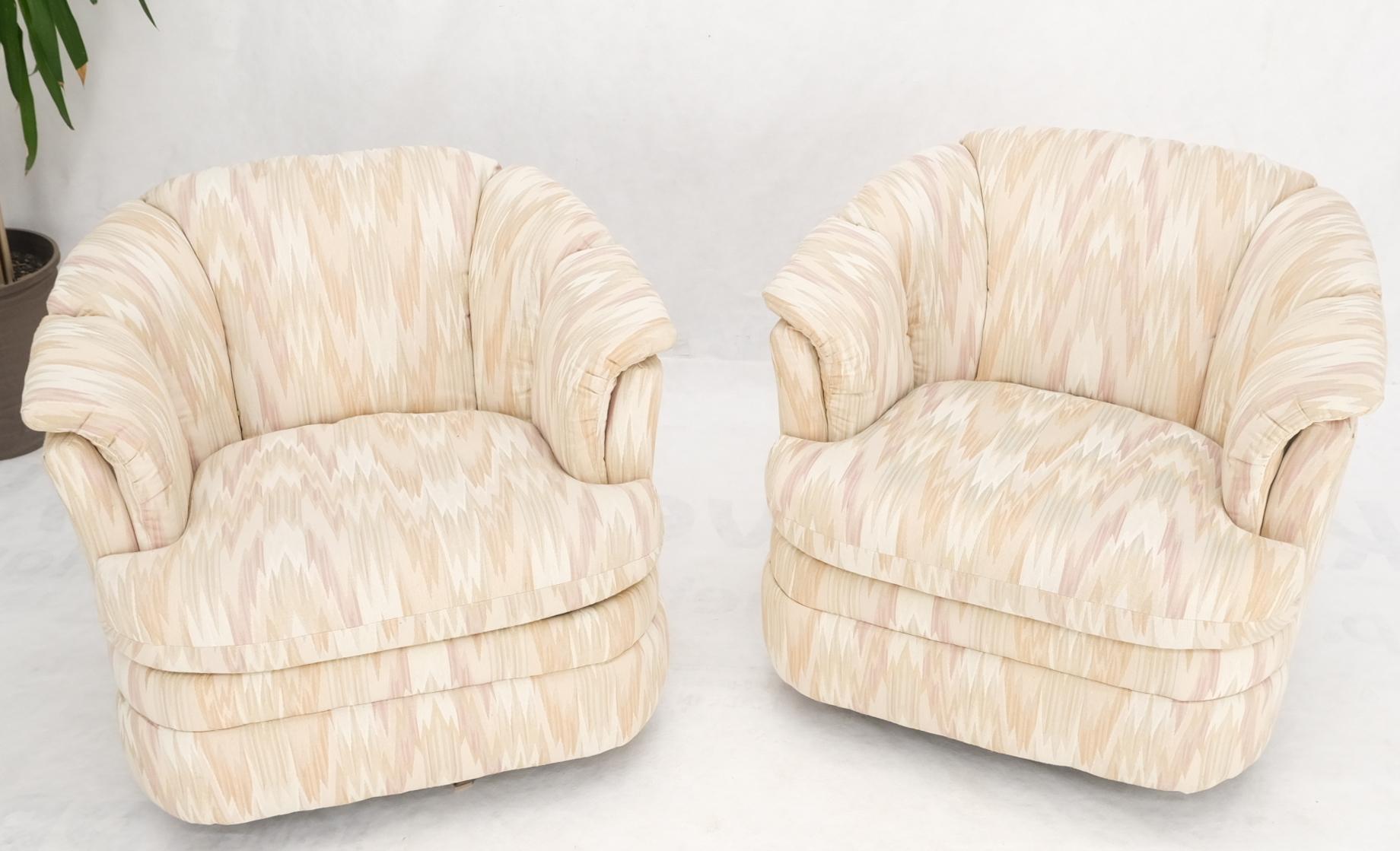 Pair of Milo Baughman Inspired swivel lounge chair in beige and pink stichflame fabric upholstery.