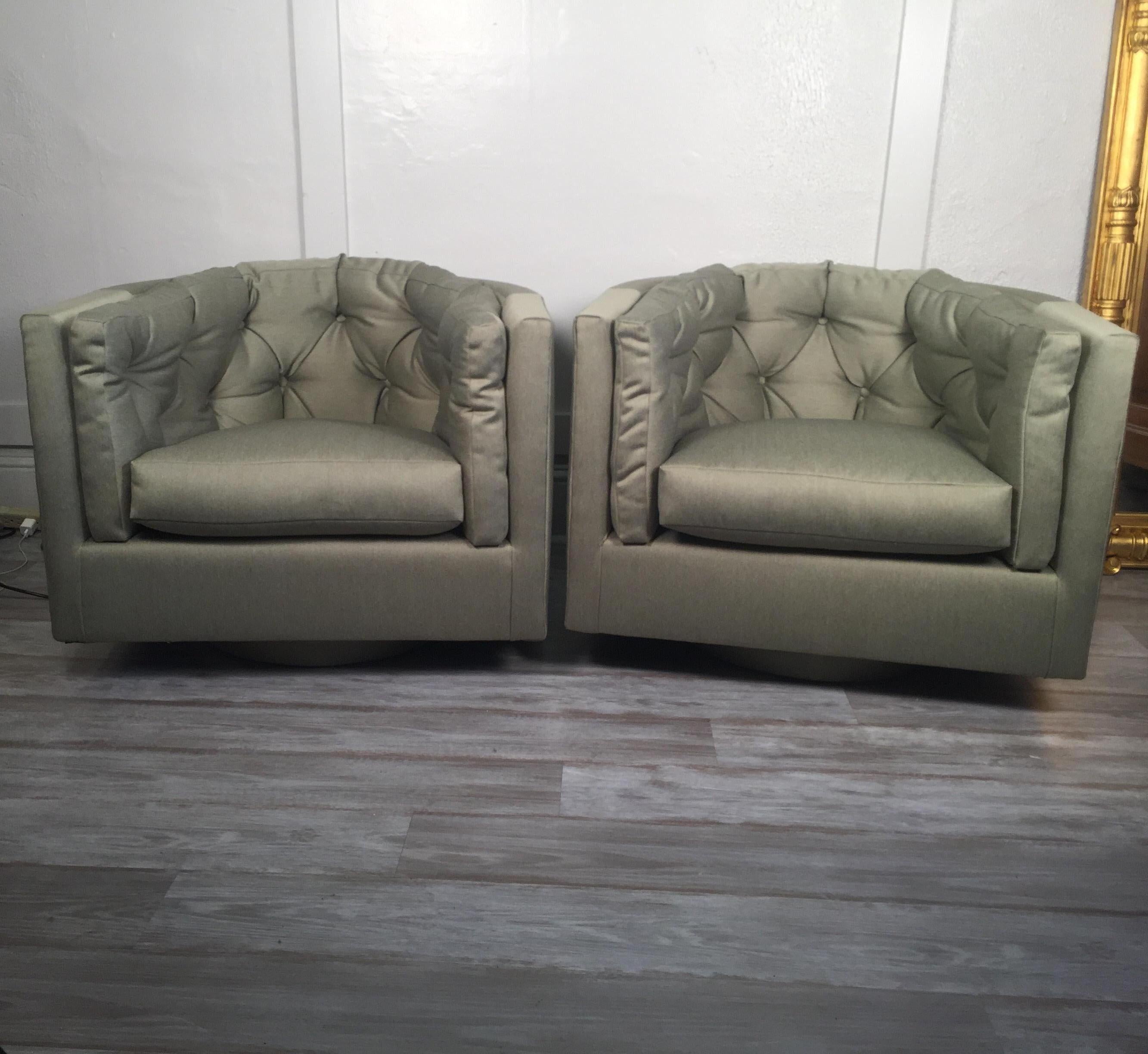 Pair of swiveling barrel-back chairs with new button-tufted upholstery.