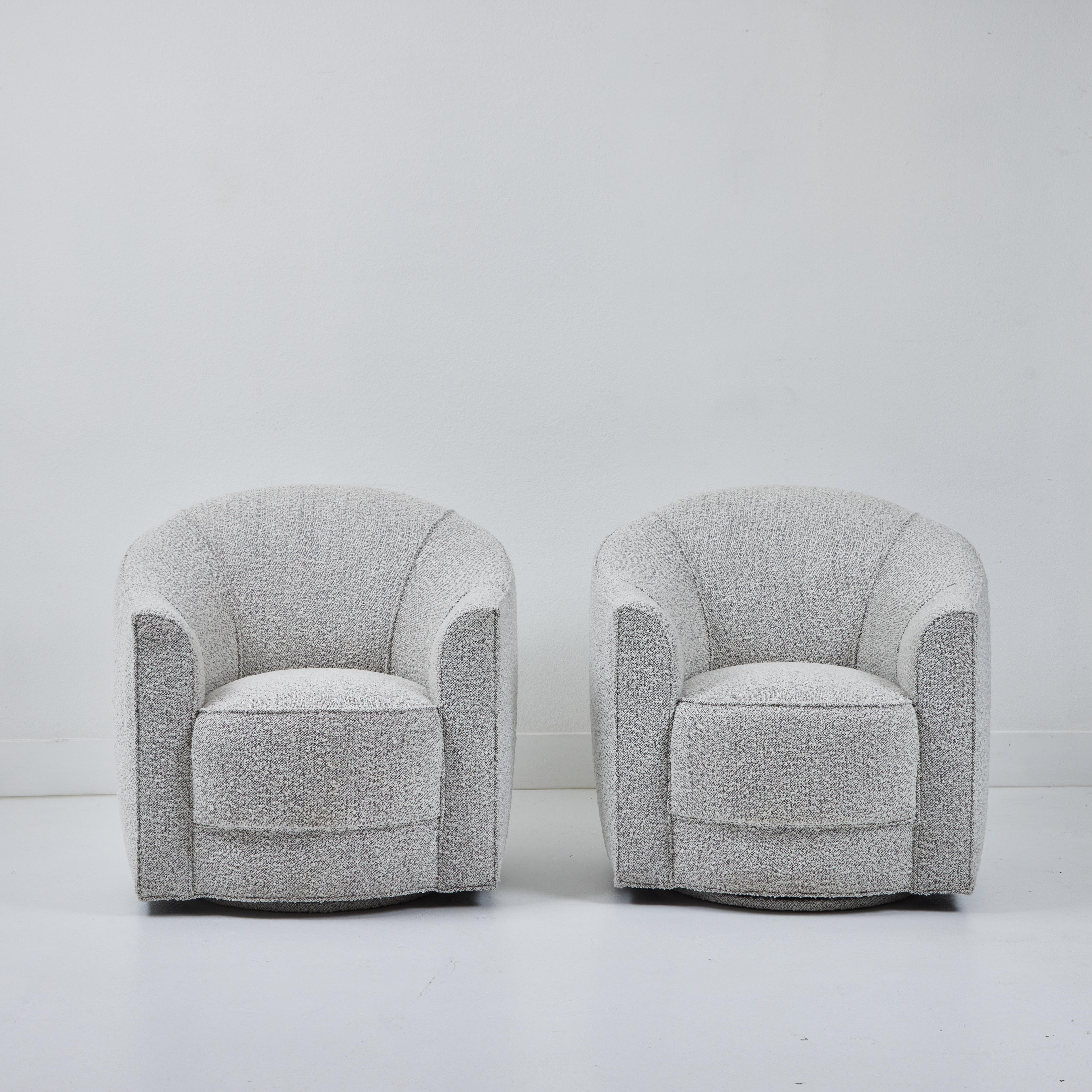 These two newly restored swiveling club chairs came from the estate of Don Rickles.    The chairs have been rebuilt and are reupholstered in a beautiful cream bouclé with grey undertones. These chairs are incredibly comfortable. They are as sturdy