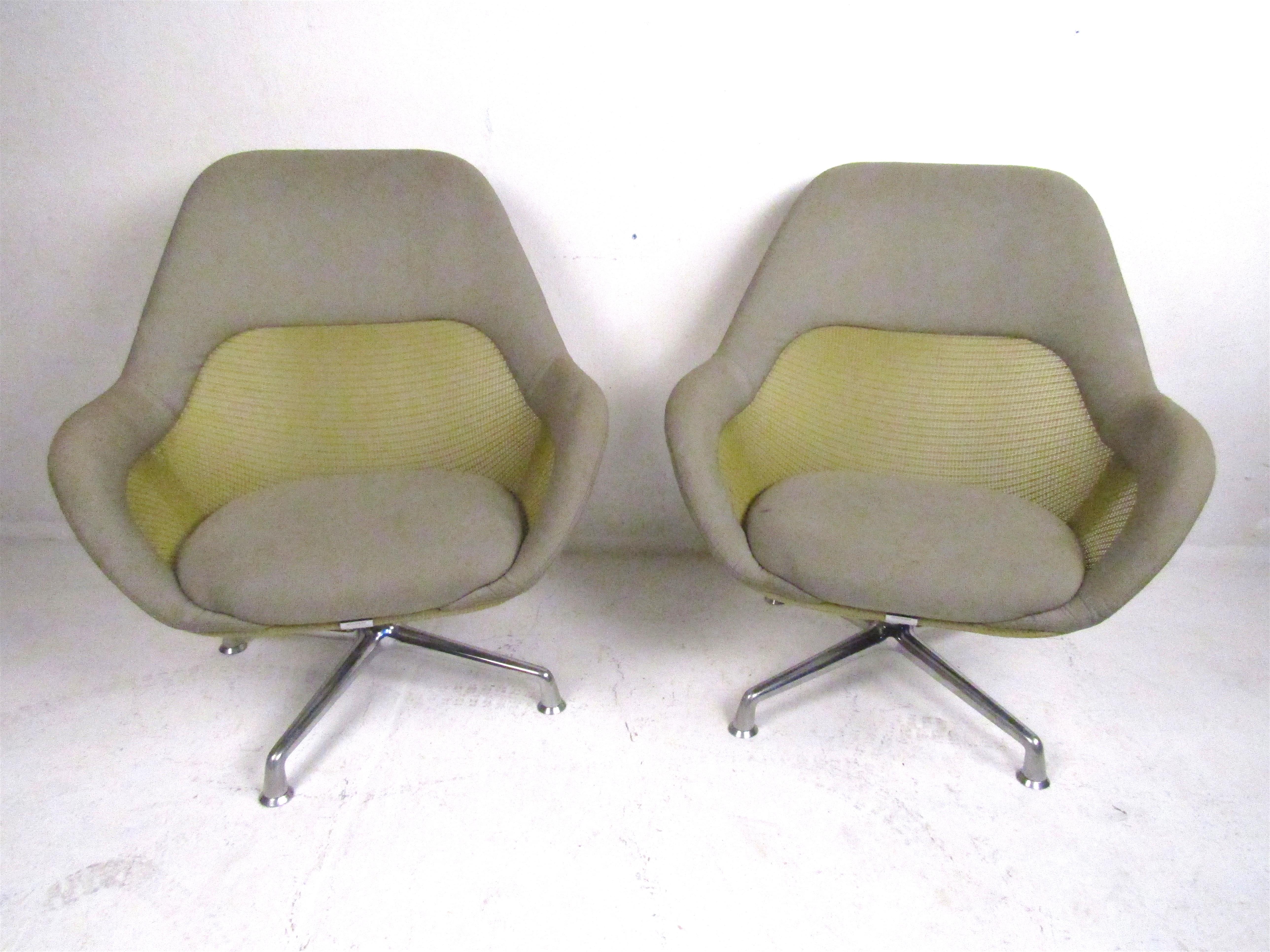 A set of modern Coalesse lounge/office chairs. A beautiful color combination of grey fabric, green mesh with solid metal legs. These chairs offer a very comfortable seating position as well as the ability to swivel making them a great addition to