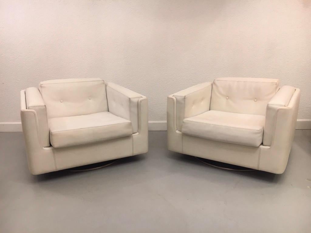 Rare pair of swiveling white capitoned faux leather 
