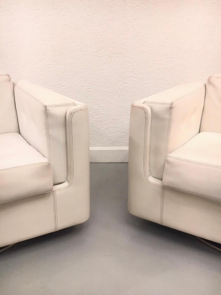 Pair of Swiveling White Faux Leather 