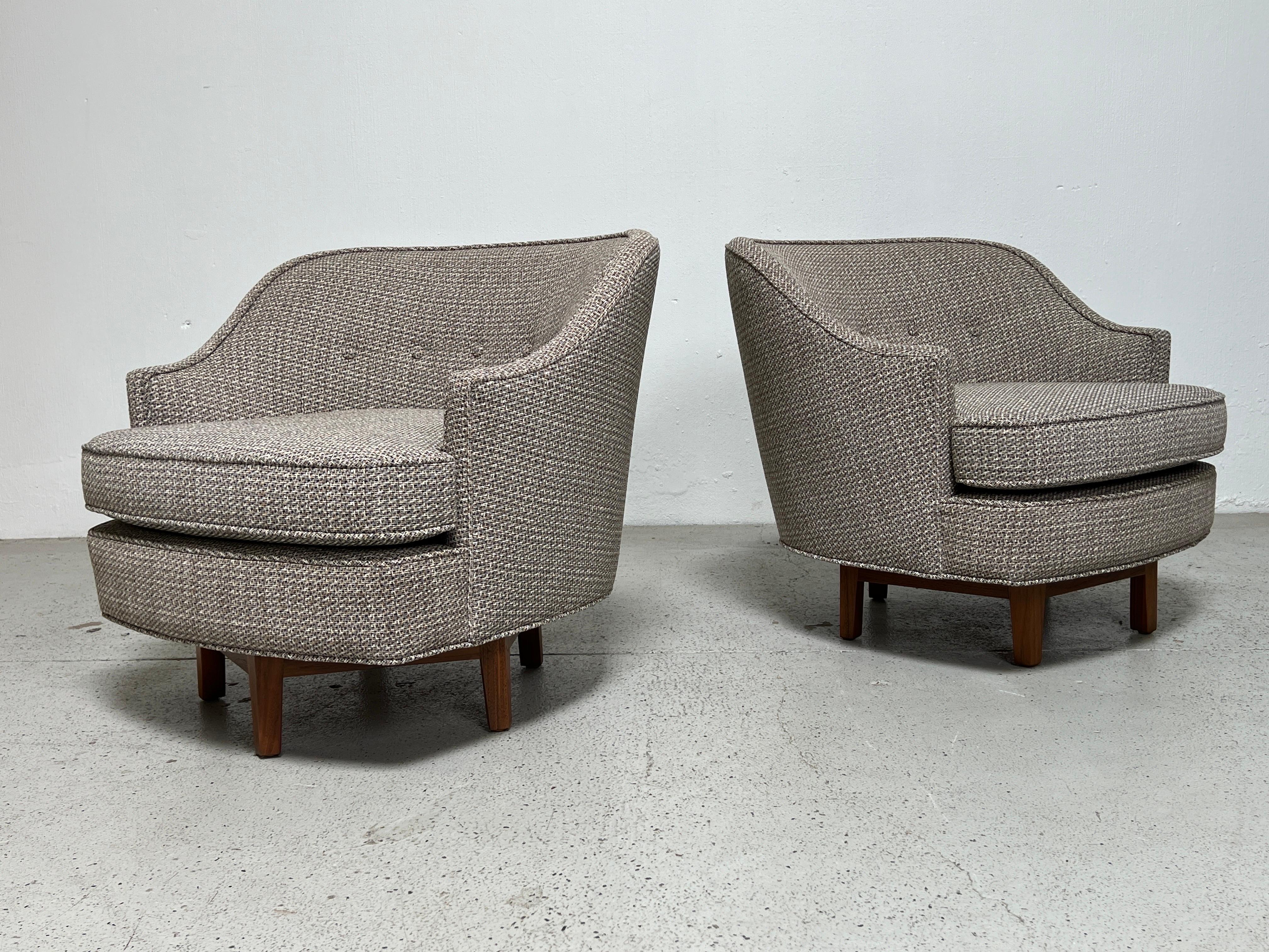 A pair of Janus swivel chairs with walnut bases. Designed by Edward Wormley for Dunbar. Fully restored, refinished and reupholstered.
*Four matching chairs available. 