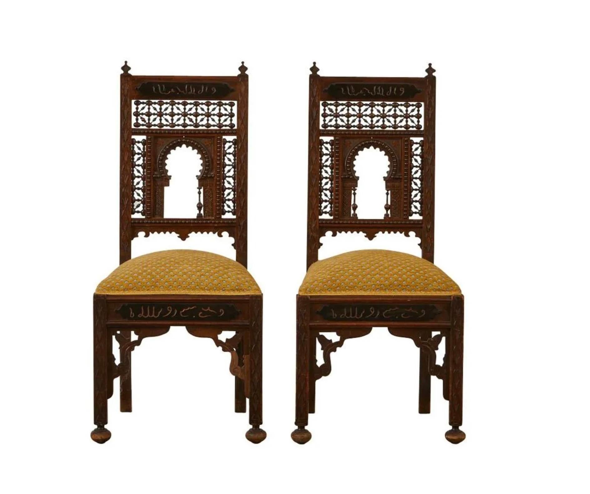 Pair of Syrian carved wood side chairs with mashrabiya style latticework backs. The back and skirting are incised with Arabic inscriptions. With upholstered seats.

Provenance: From the Estate of Horst Rechelbacher, Osceola, Wisconsin.

Horst