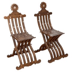 Pair of Syrian Damascus carved walnut folding chairs, c. 1900