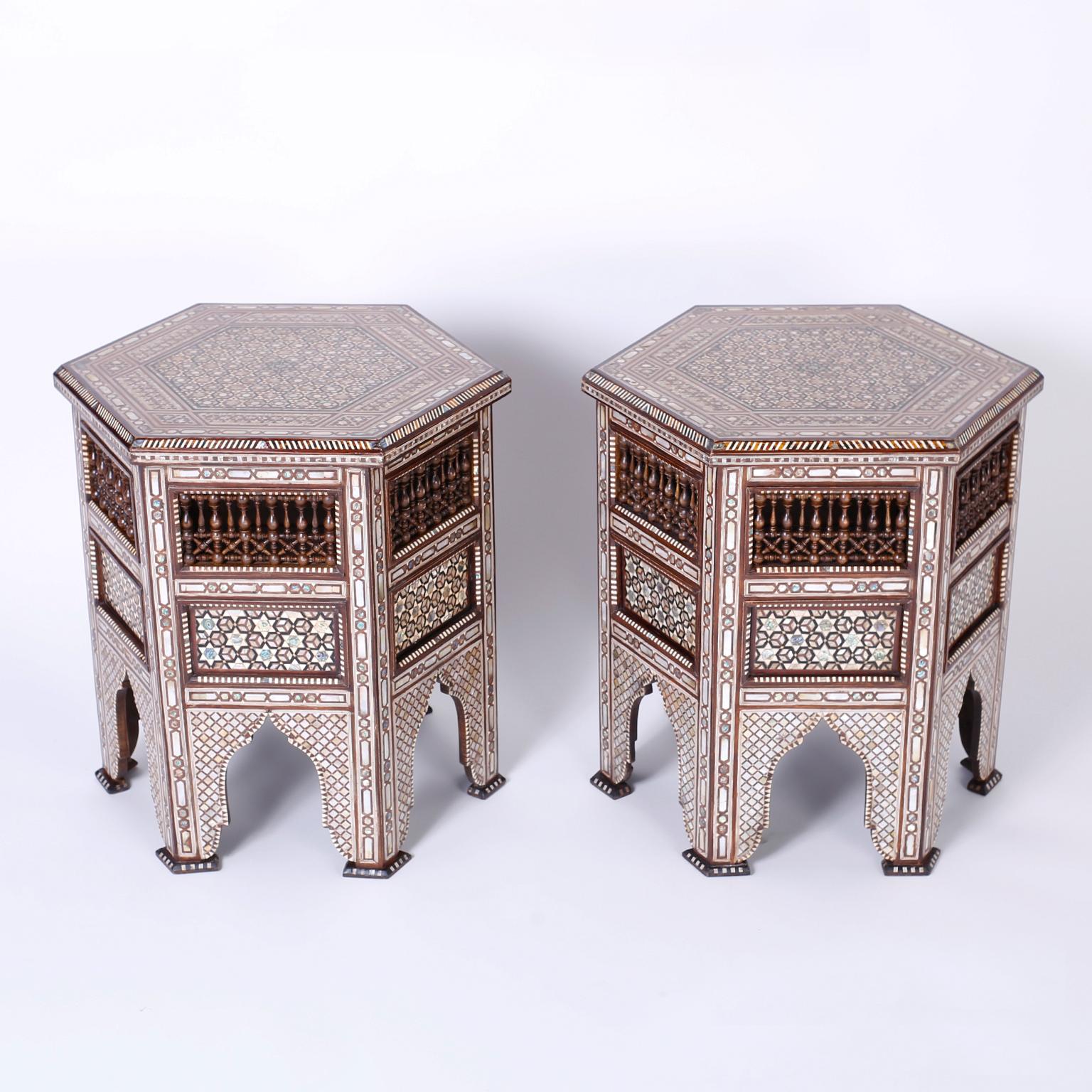 Stand out pair of Syrian walnut tables with a hexagon form and featuring elaborate geometric inlays of mother of pearl, bone and exotic hardwoods, stick and ball panels and six legs separated by Moorish arches. Best of the genre.