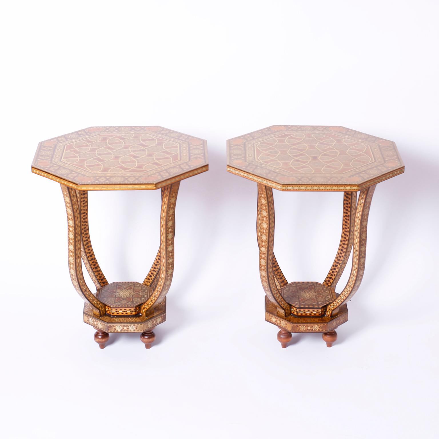 Sophisticated pair of Syrian tables with octagon tops intricately inlaid with marquetry, mother of pearl, bone and indigenous hardwoods over 4 curved and inlaid supports mounted on inlaid double plinth bases, over turned