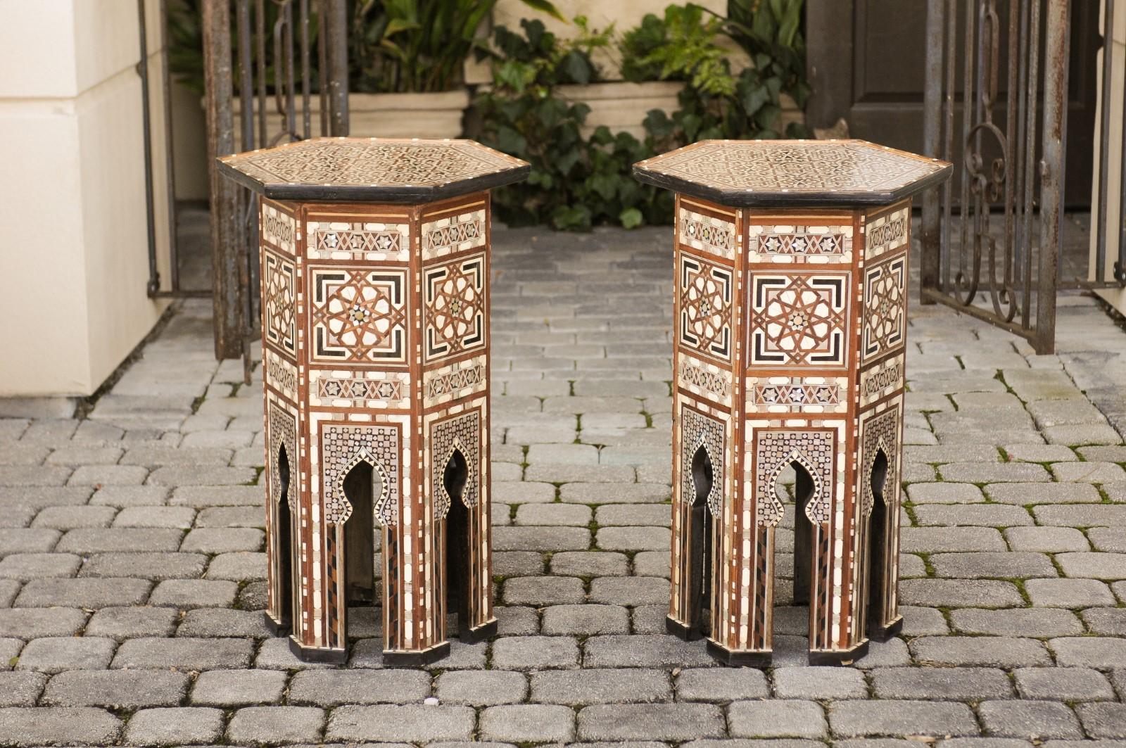 A pair of Syrian Moorish style hexagonal side tables with ebonized wood, bone and mother of pearl inlay from the 20th century. Each of this pair of Syrian tables features an exquisite décor, where no area is left untouched, evoking the 