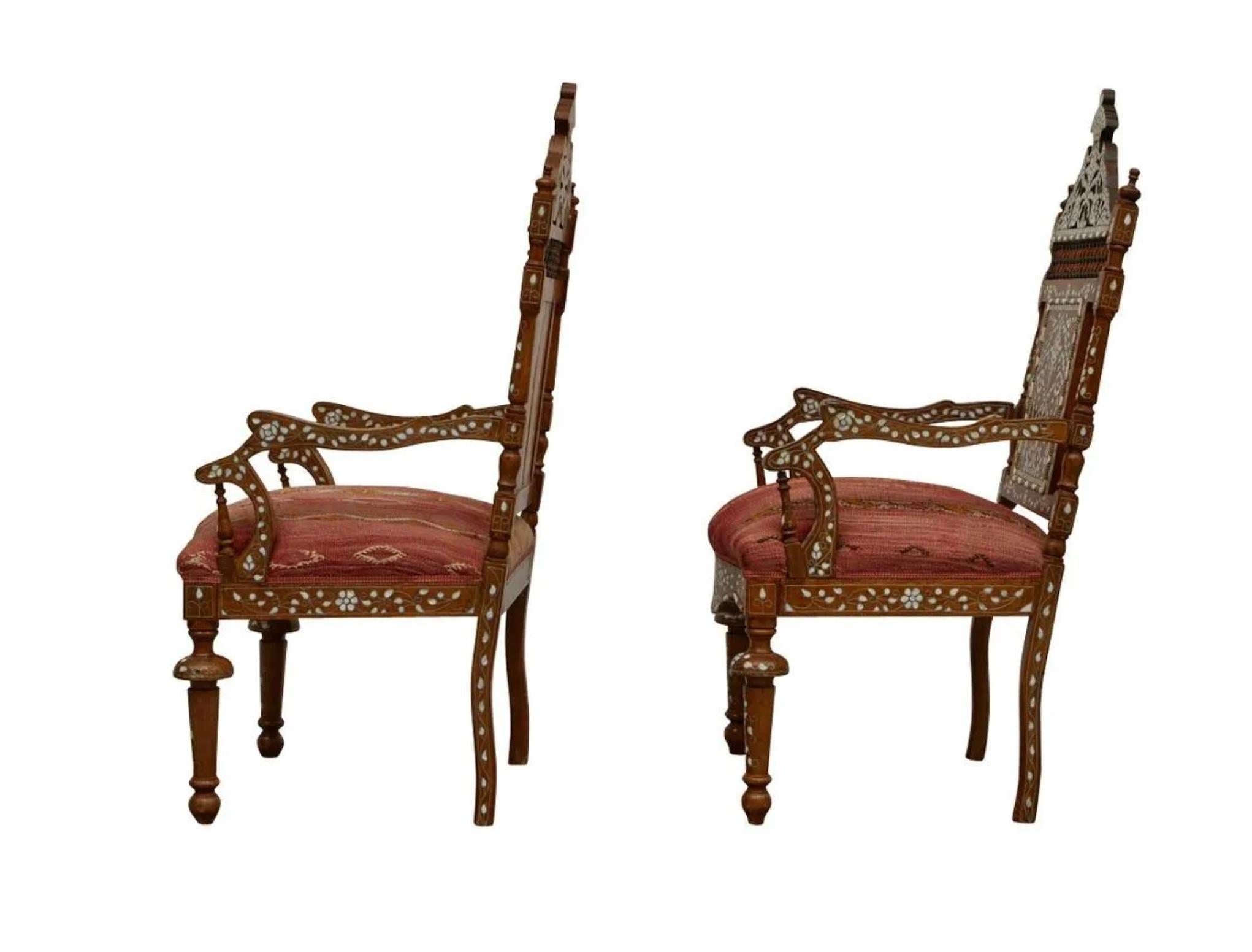 Pair of Syrian mother-of-pearl inlaid wooden armchairs. Richly decorated with floral motifs in mother of pearl utilizing the intarsia method. With matching upholstered seats.

Provenance: From the Estate of Horst Rechelbacher, Osceola,