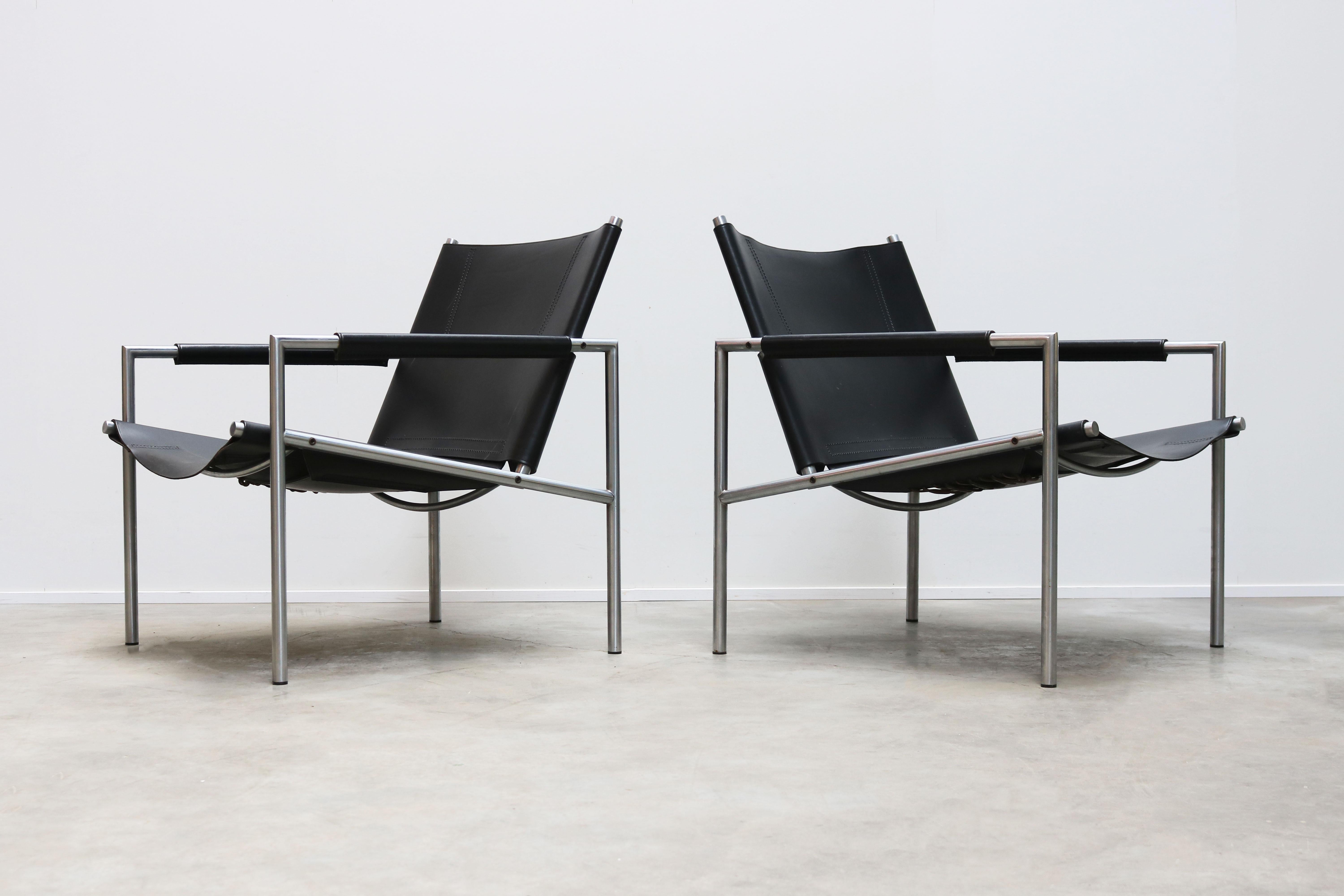 Magnificent pair of SZ01 Minimalist lounge chairs in black leather and chrome by Dutch Industrial designer: Martin Visser for T' Spectrum in 1960. The Minimalist tubular chrome frame in combination with the leather armrests and leather back/seat