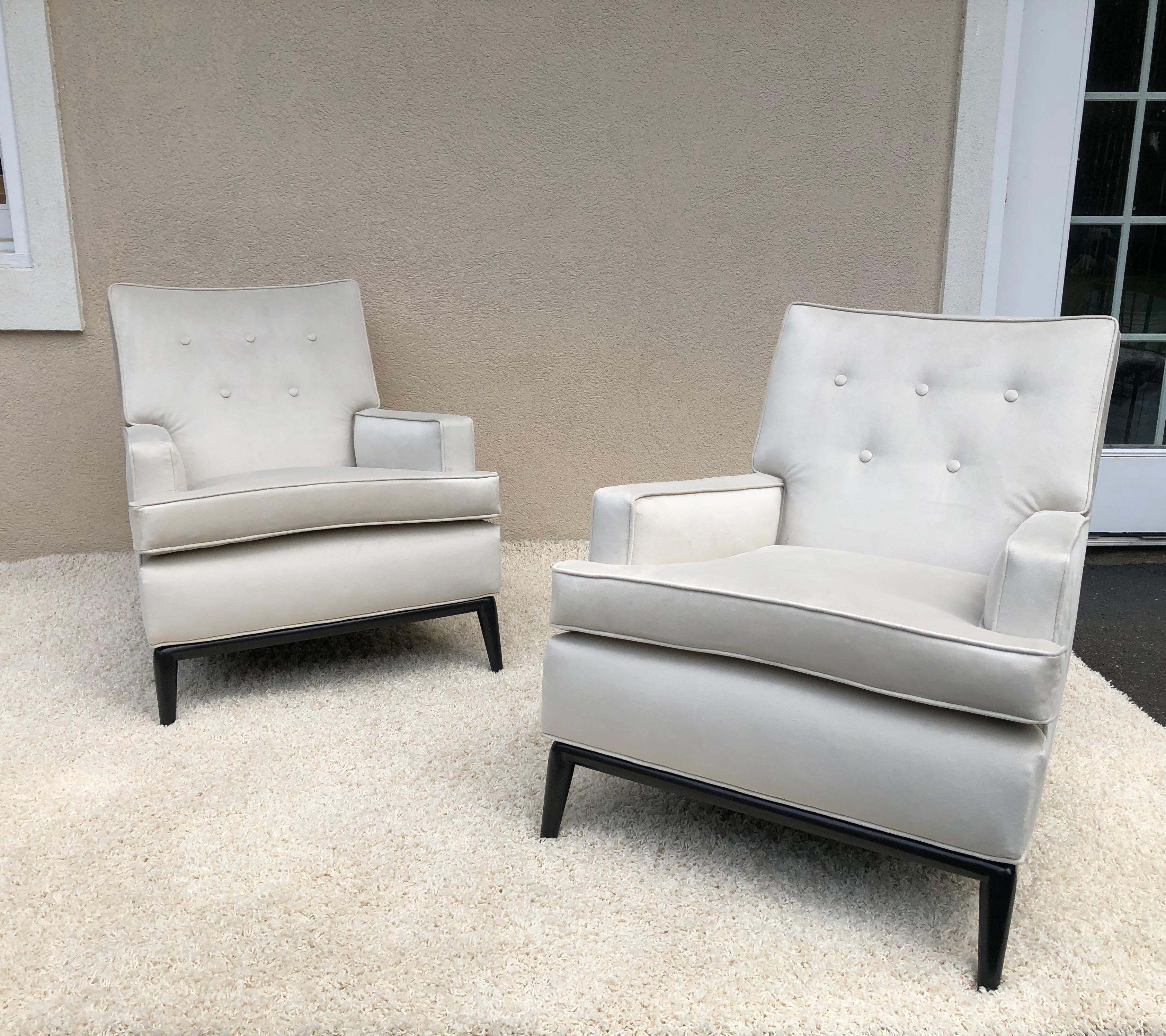 Pair of T-H Robsjohn Gibbings club chairs dark walnut base, with a light off white
Ultra suede velvet look fabric, custom size per clients 1950s.