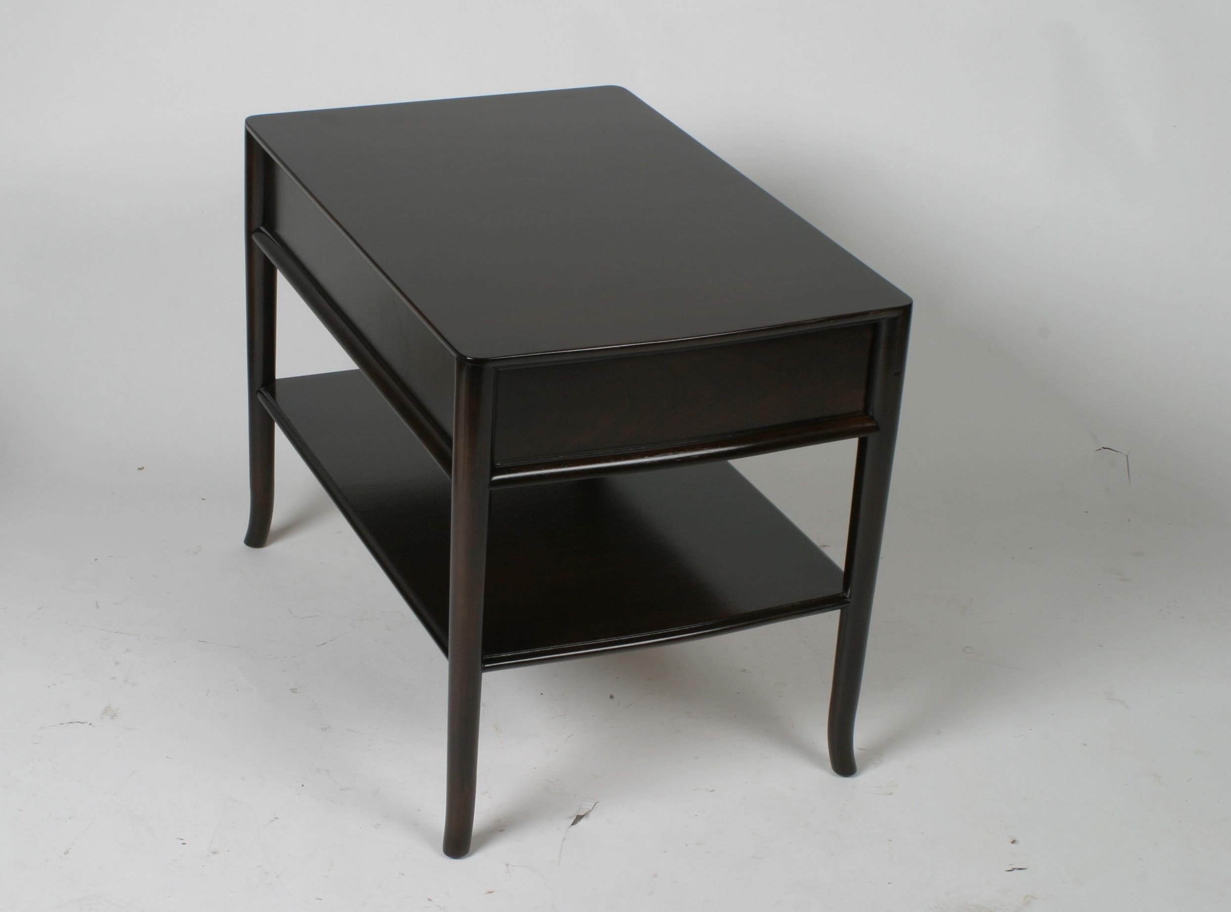 Elegant matching pair of T. H. Robsjohn-Gibbings for Widdicomb nightstands with serpentine curved fronts, drawer, lower shelf, and having elegant tapered legs that curve outward at the bottom. Dark brown finish on walnut, Label, dated 1957. To be