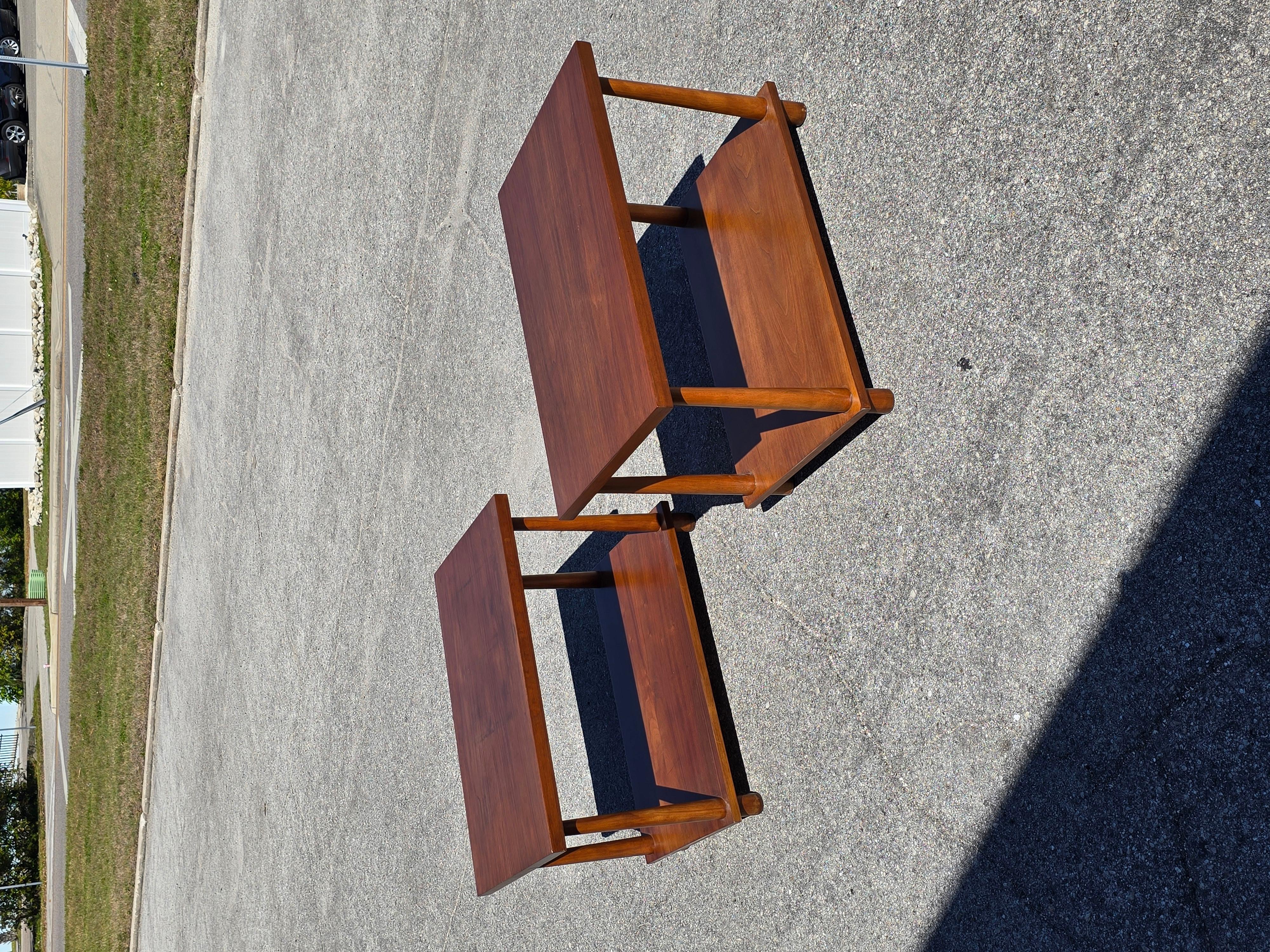 Pair of reverse taper leg end tables designed by T H Robsjohn Gibbings and produced by Widdicomb.  Retaining original label to underside and date.  While these have been gone over and refinished, as shown in photos there is a repair to a corner and