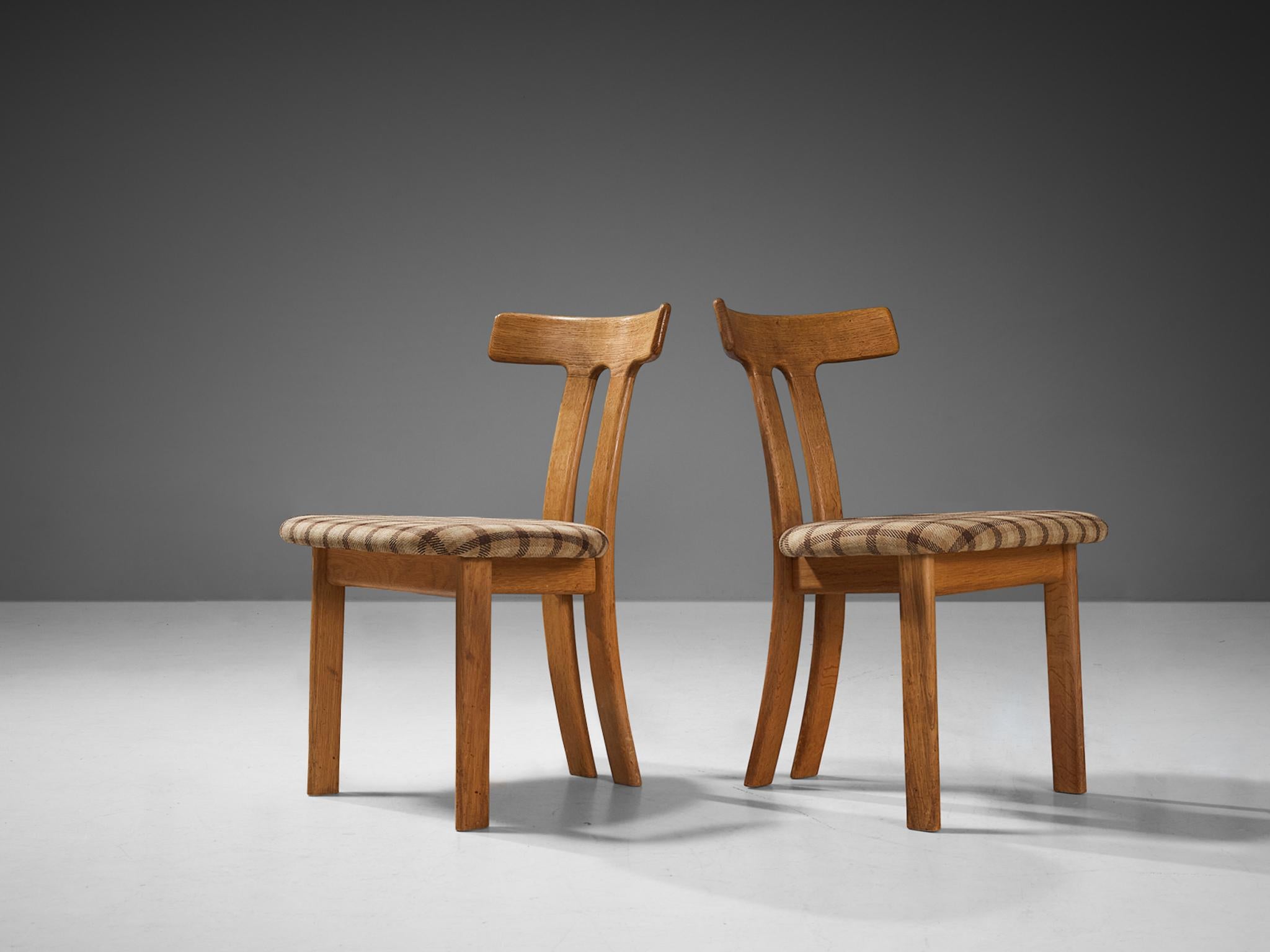 Pair of dining chairs, oak, fabric, France, 1960s. 

These dining chairs have a strong resemblance to Carl Hansen's t-chair and the dining chairs by Sapporo for Mobil Girgi, yet this design is different in its details. Strong vertical and horizontal