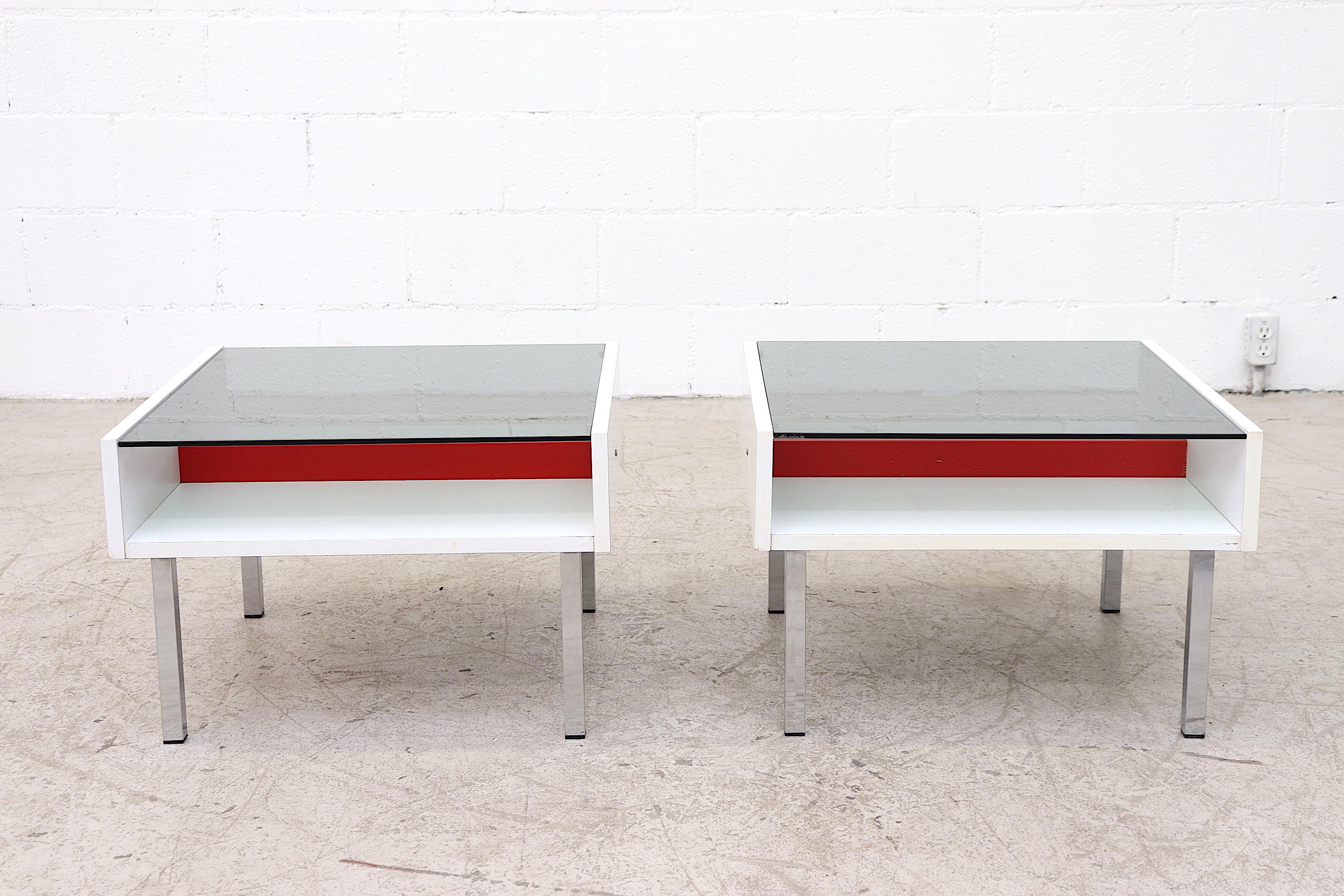 Pair of matching white and red formica coffee or side tables with smoked glass tops and squared chrome legs. In original condition with visible wear consistent with their age and use. Set price.