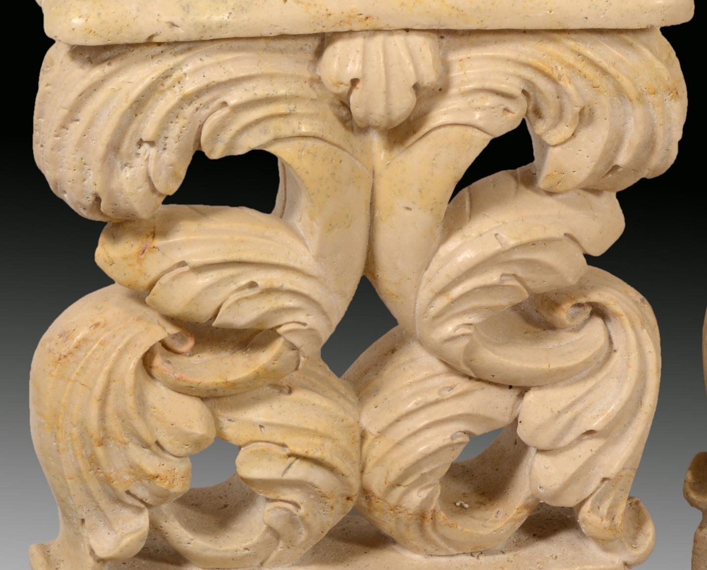 Pair of table legs in carved travertine. 
 Both the same, they have been decorated with fleshy leaves arranged symmetrically, which are reminiscent of tropical examples more than classical-inspired acanthus. The prominence of the natural element of