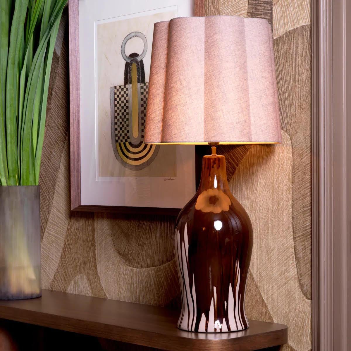 Choose refinement with this table lamp, featuring a brown ceramic base with a distinctive drip effect, enhanced with a touch of vintage brass.
This unique piece has a specially designed linen blend lampshade, giving it unrivalled charm and elegance.