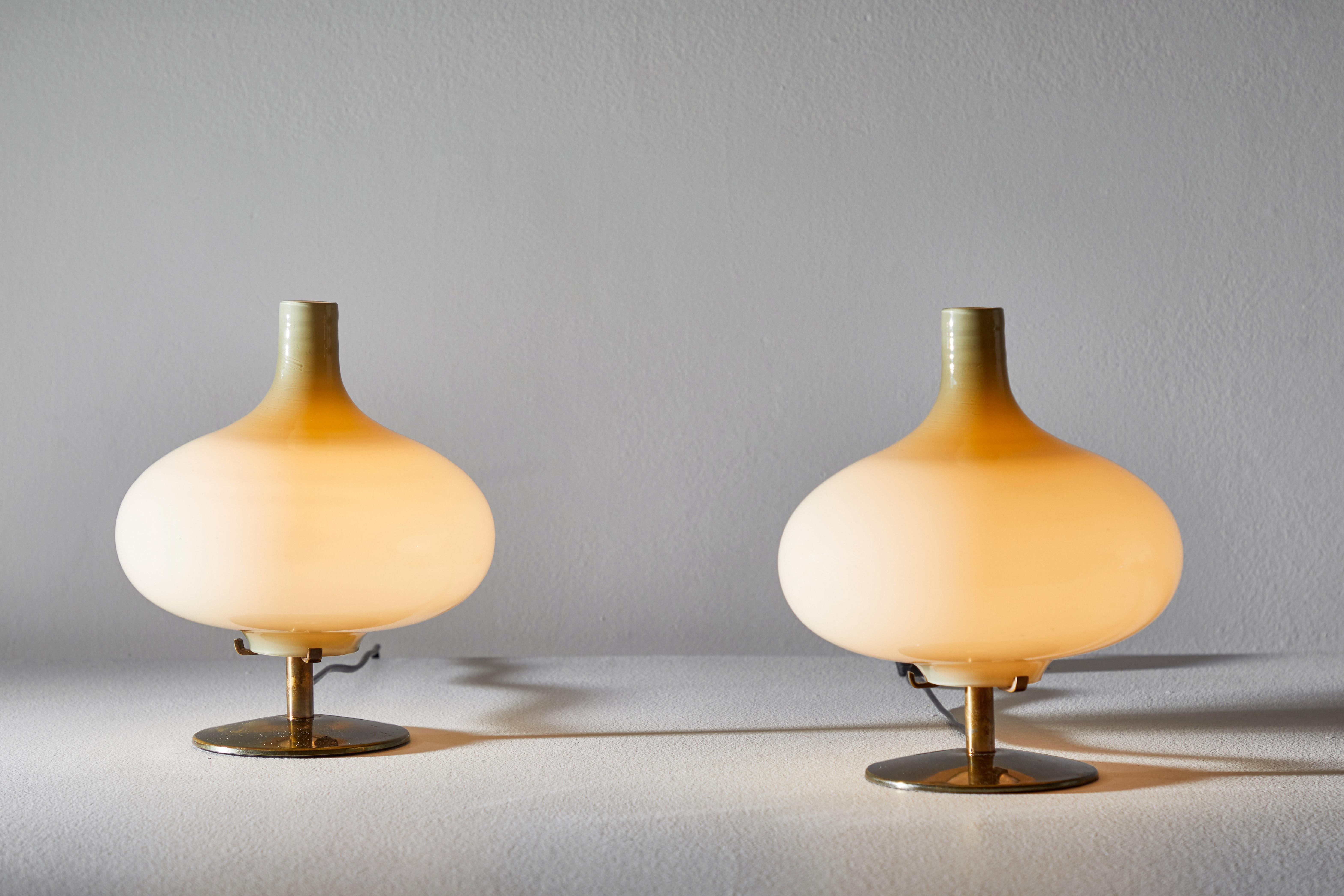 Pair of table lamps by Annig Sarian. Manufactured in Adrasteia, Italy, 1960. Brass, blown glass diffuser. Original cord. Each light takes one E27 European candelabra 60w maximum bulb. Bulbs provided as a one time courtesy. Literature: Bibliography