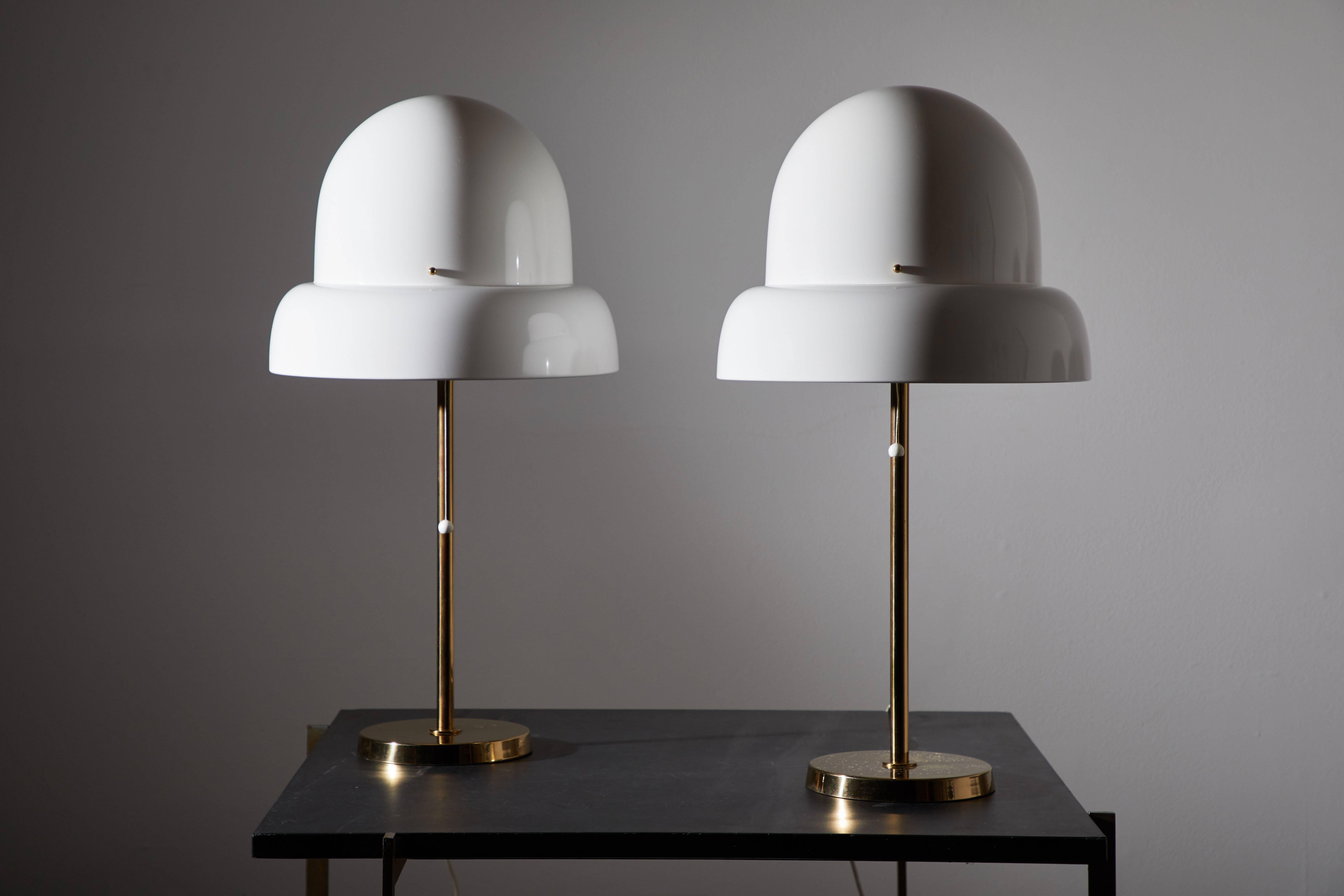 Pair of table lamps by Bergboms. Manufactured in Sweden, circa 1970s. Acrylic shades with brass stems and hardware. Original cords. Each light takes one E27 75w maximum bulb.