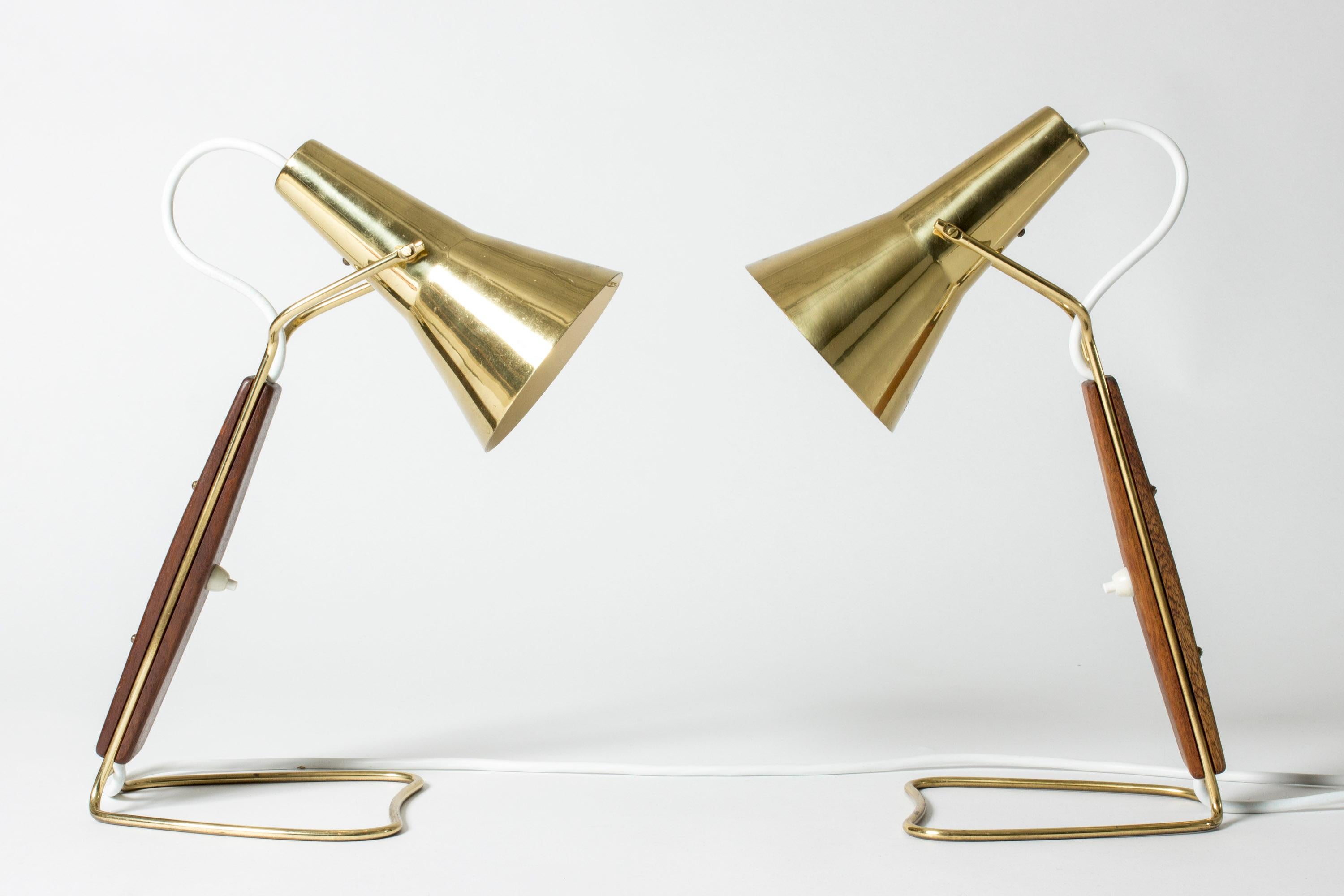 Pair of amazing table or desk lamps by Hans Bergström for ASEA, made from brass with teak handles. Luxurious design with cool, open silhouettes.