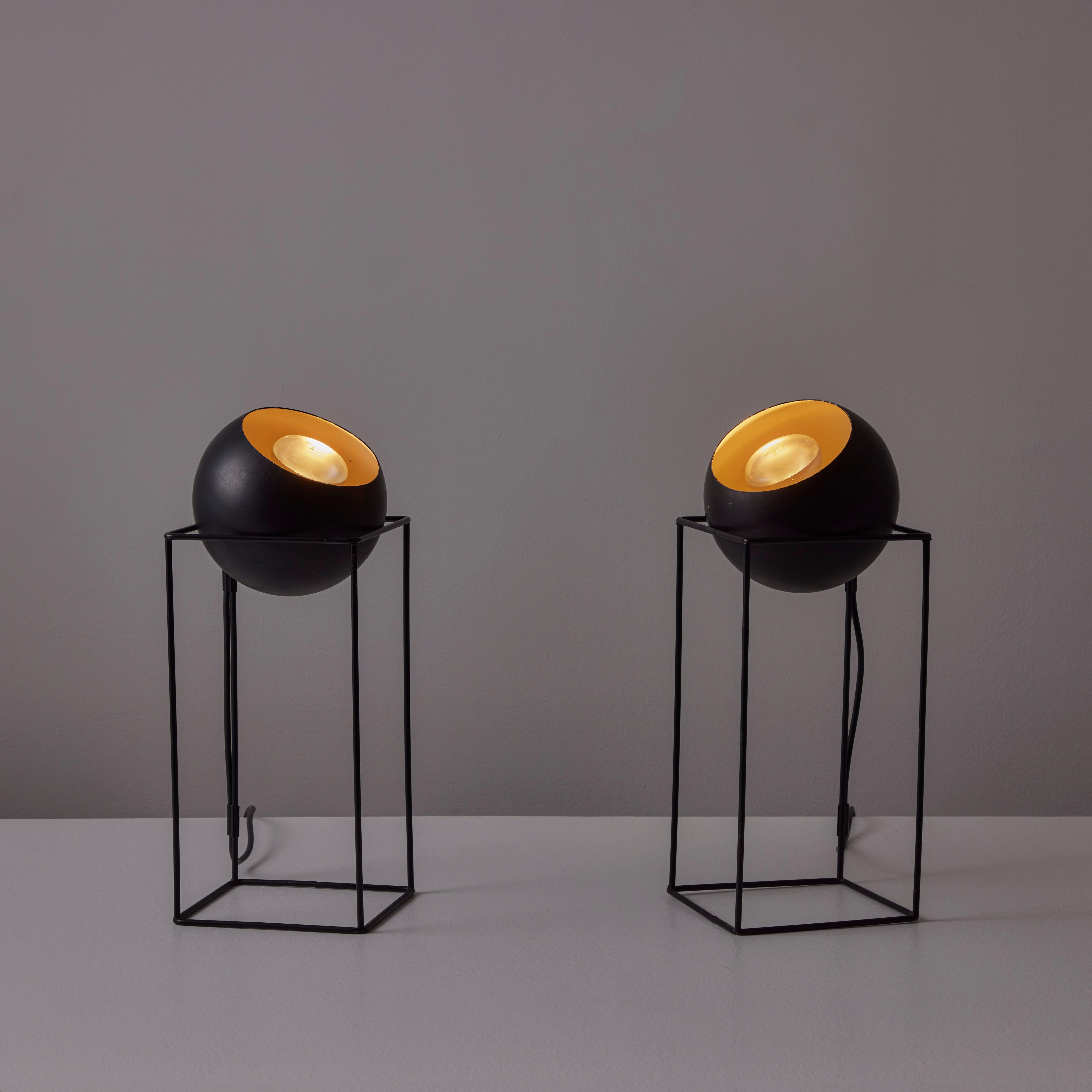 Pair of Table Lamps by Raymor. Designed and manufactured in the USA, circa the 1950s. Enameled steel rodded frames and moveable ball shades. The ball shades can be handled to move the direction of the light. Each lamp holds an E26 socket type. We