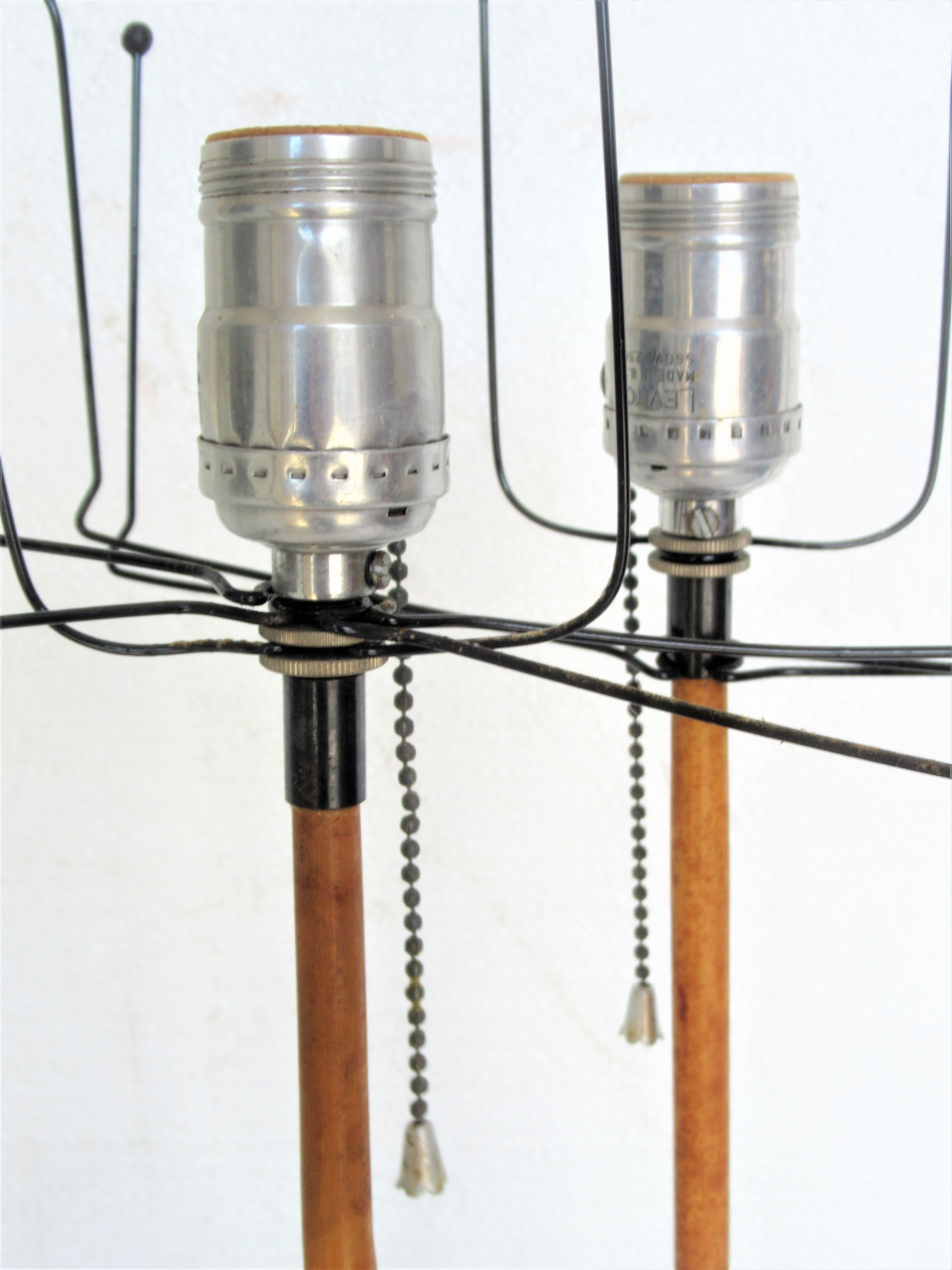 A pair of early vintage Isamu Noguchi (1904-1988) black cast iron base table lamps with bamboo shafts. Each cast signed on underside of iron base, Akari, Japan, circa 1960s. First time for sale, direct from a private local estate collection. They