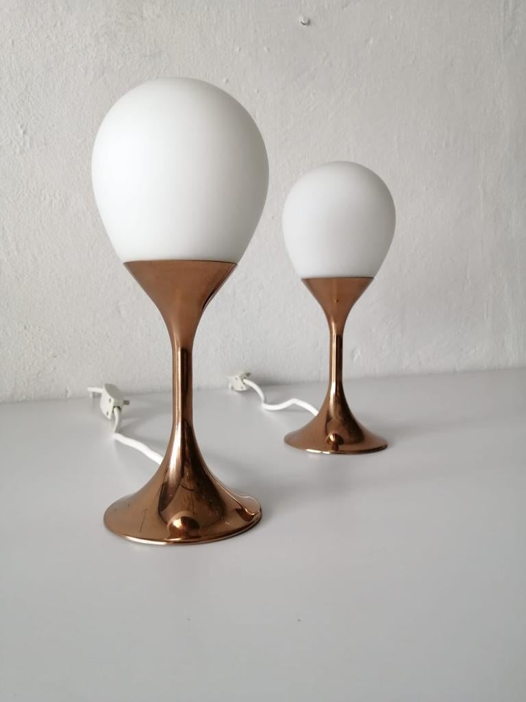 Opaline glass and metal pair of atomic age table lamps by Kaiser Leuchten, 1970s, Germany

Rare oval opaline glass and copper colored metal tulip base

Very high quality.
Fully functional.
Original cable and plug. These lamps is suitable for