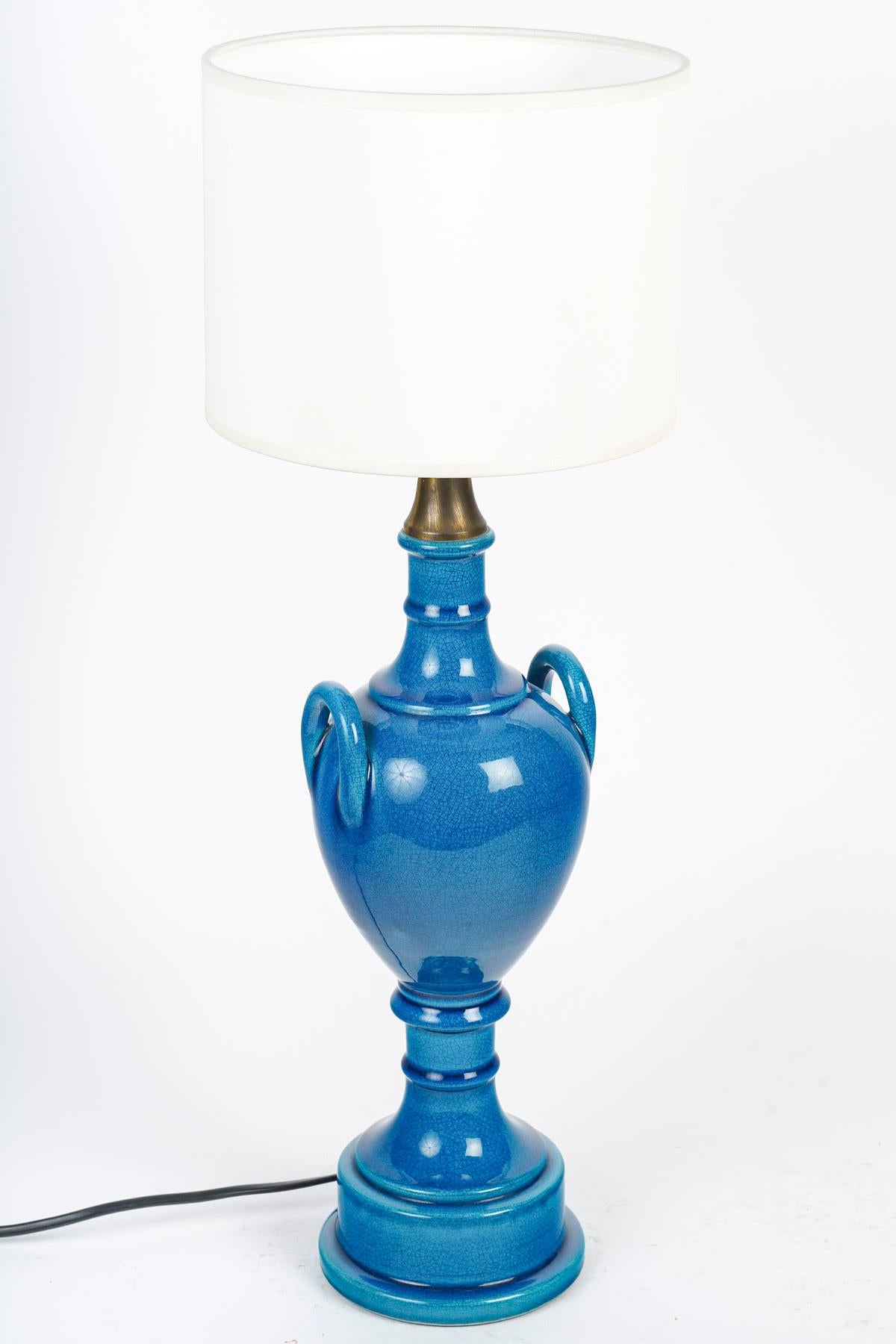 Pair of table lamps by Pol Chambost (1906-1983), Blue glazed earthenware.

Pair of 20th century blue enamelled porcelain table lamps by Pol Chambost (1906-1983), signed.
Excluding shade: h: 36cm, d: 12.5cm