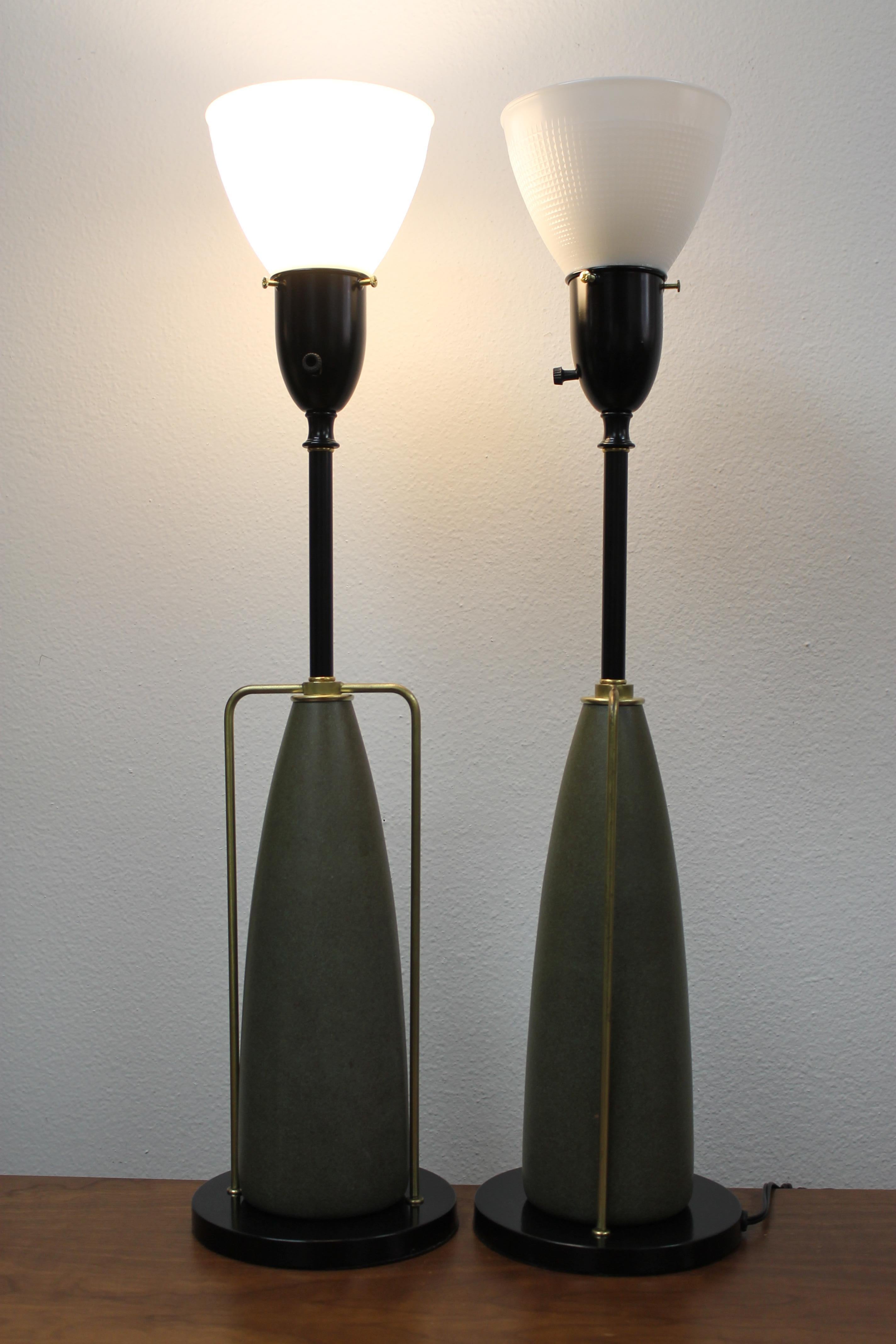 Pair of table lamps by the Rembrandt Lamp Company. The painted wood cones are accented by brass rod supports. Lamps are 7” diameter and 29” high from base to the top of glass globe. Lamps have been professionally refurbished and rewired for 3-way