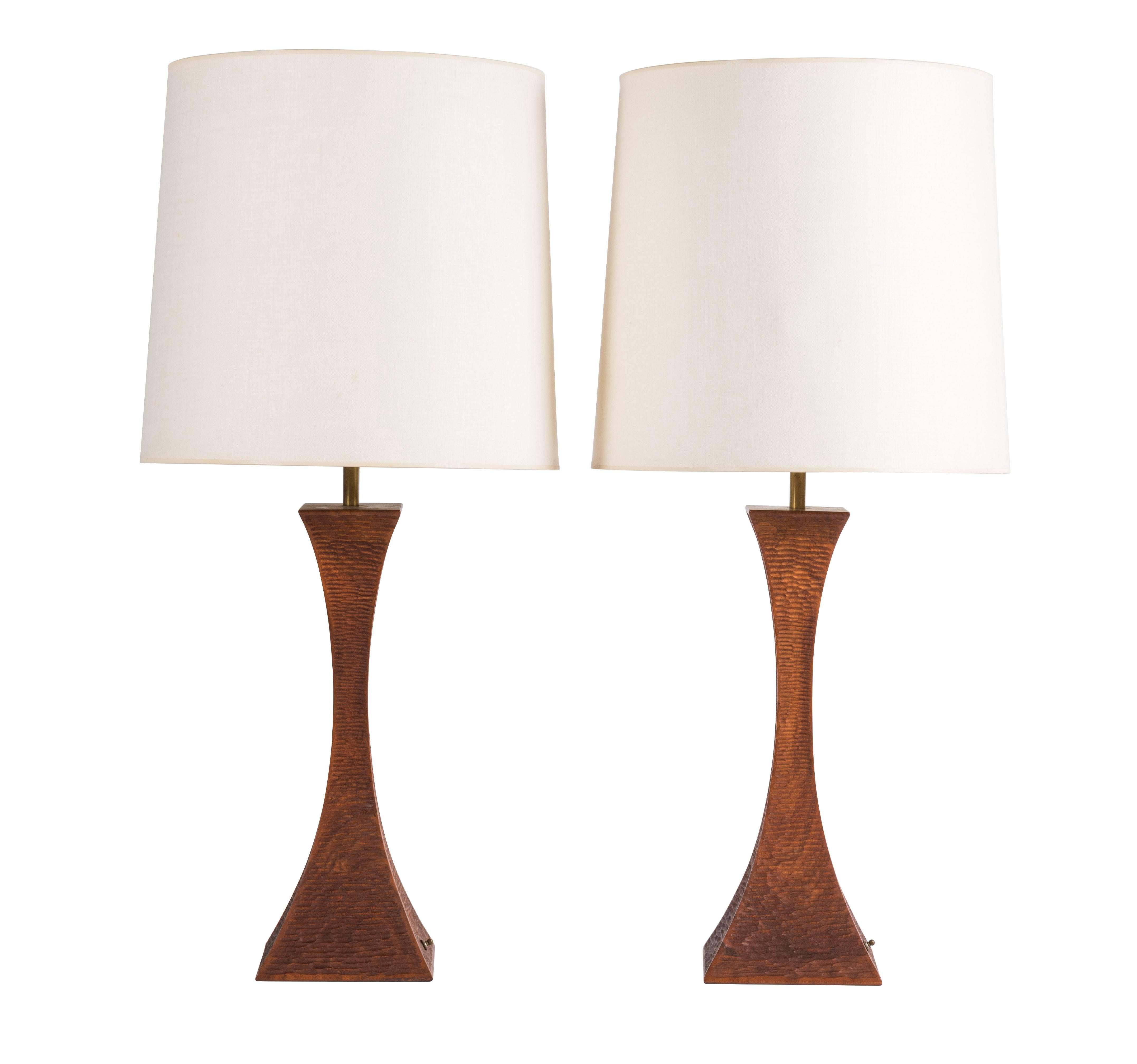 Pair of walnut chip-carved walnut table lamps by Robert Whitley. These lamps and the following listing are from a single owner named Florence Green, who commissioned Whitley to create a large collection of his work between 1965-1975 for her home in
