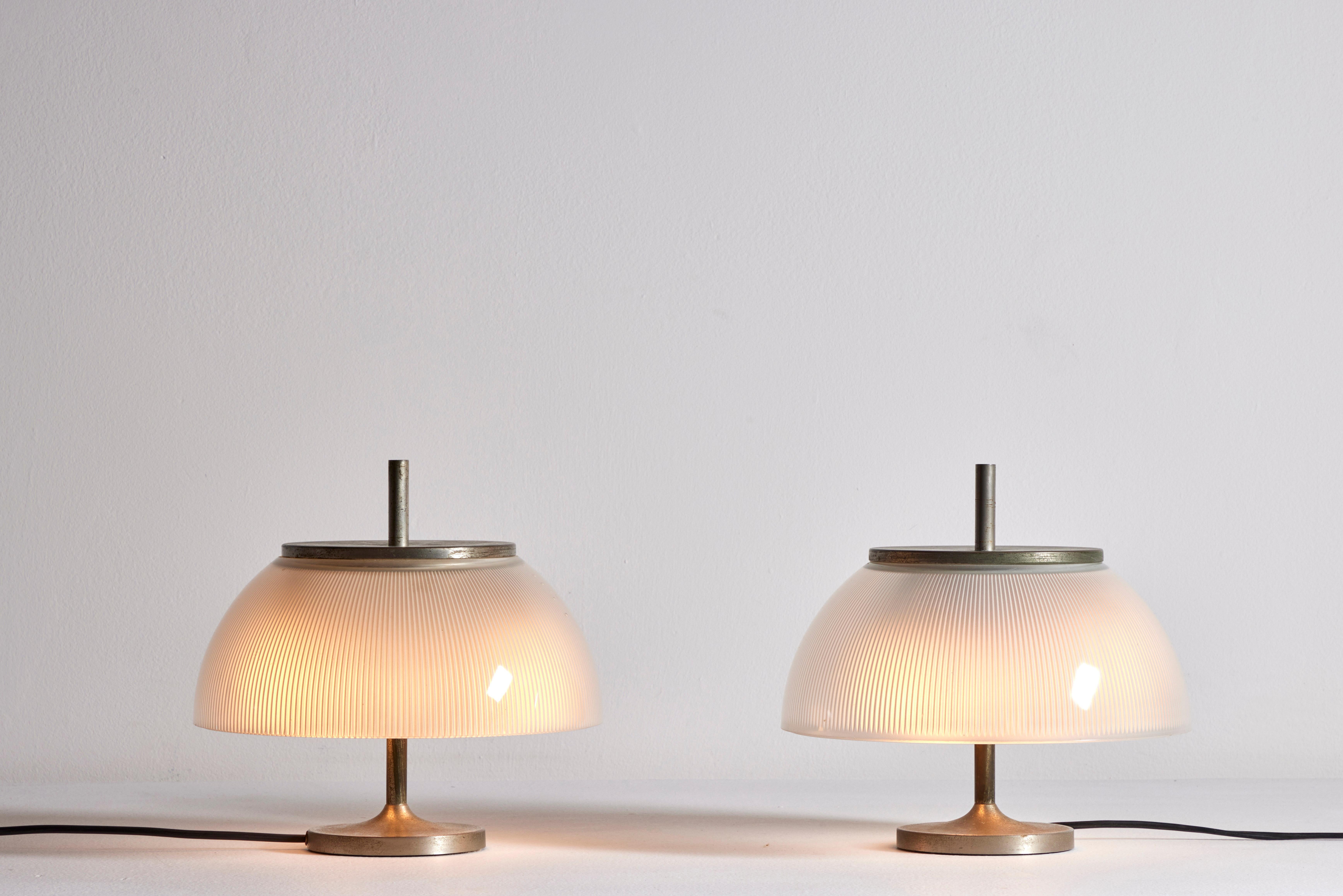 Pair of Alfetta table lamps by Sergio Mazza for Artemide. Designed and manufactured in Italy, circa 1960's. Nickel-plated brass, moulded glass. We recommend two E14 40w maximum bulbs per light. Bulbs not included.