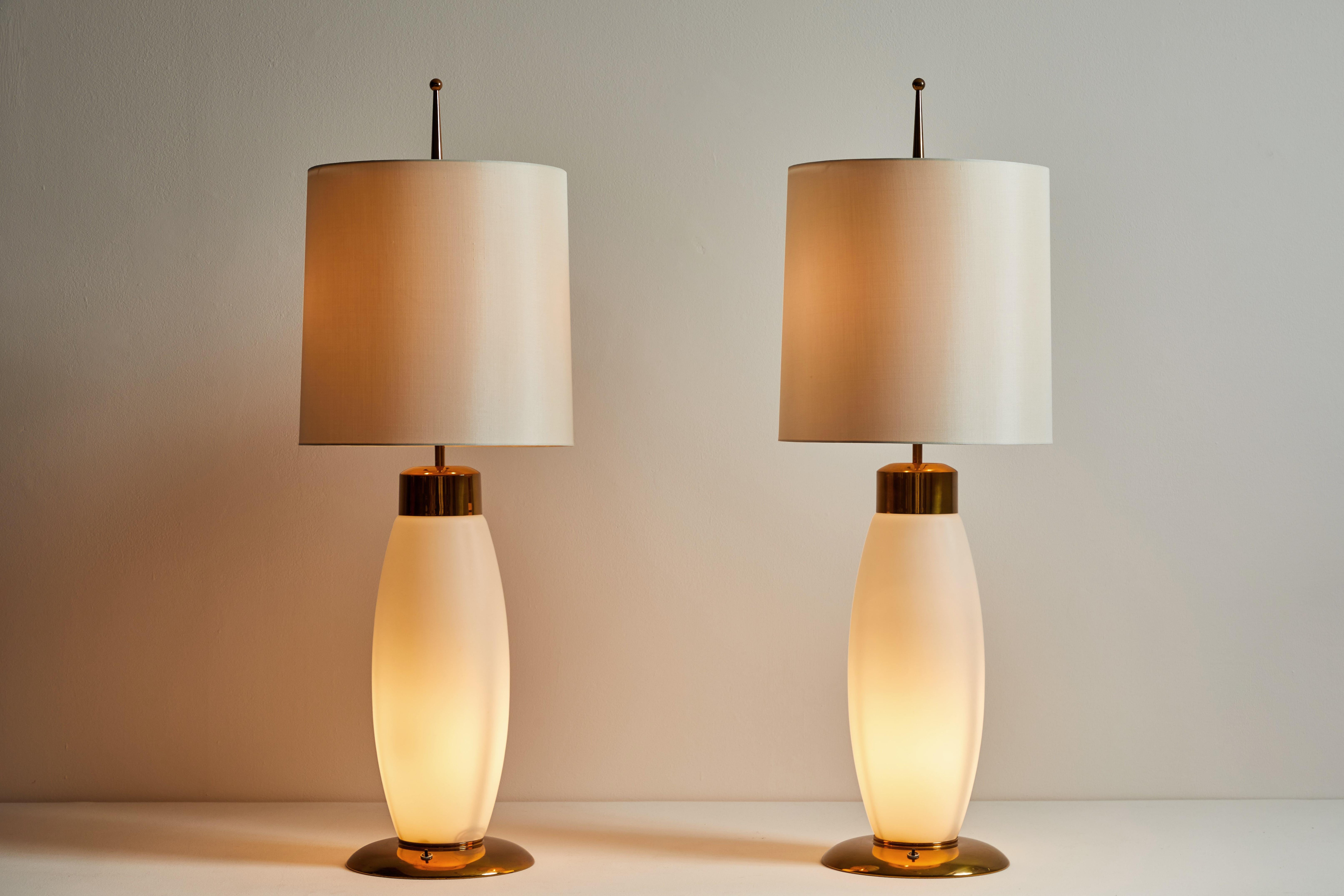 Pair of Table Lamps by Stilnovo. Manufactured in Italy, circa 1960s. Opaline glass, brass, custom silk shades. Wired for U.S standards. We recommend 3 E26 40w maximum bulbs per fixture. Bulbs provided as a one time courtesy. Retains original