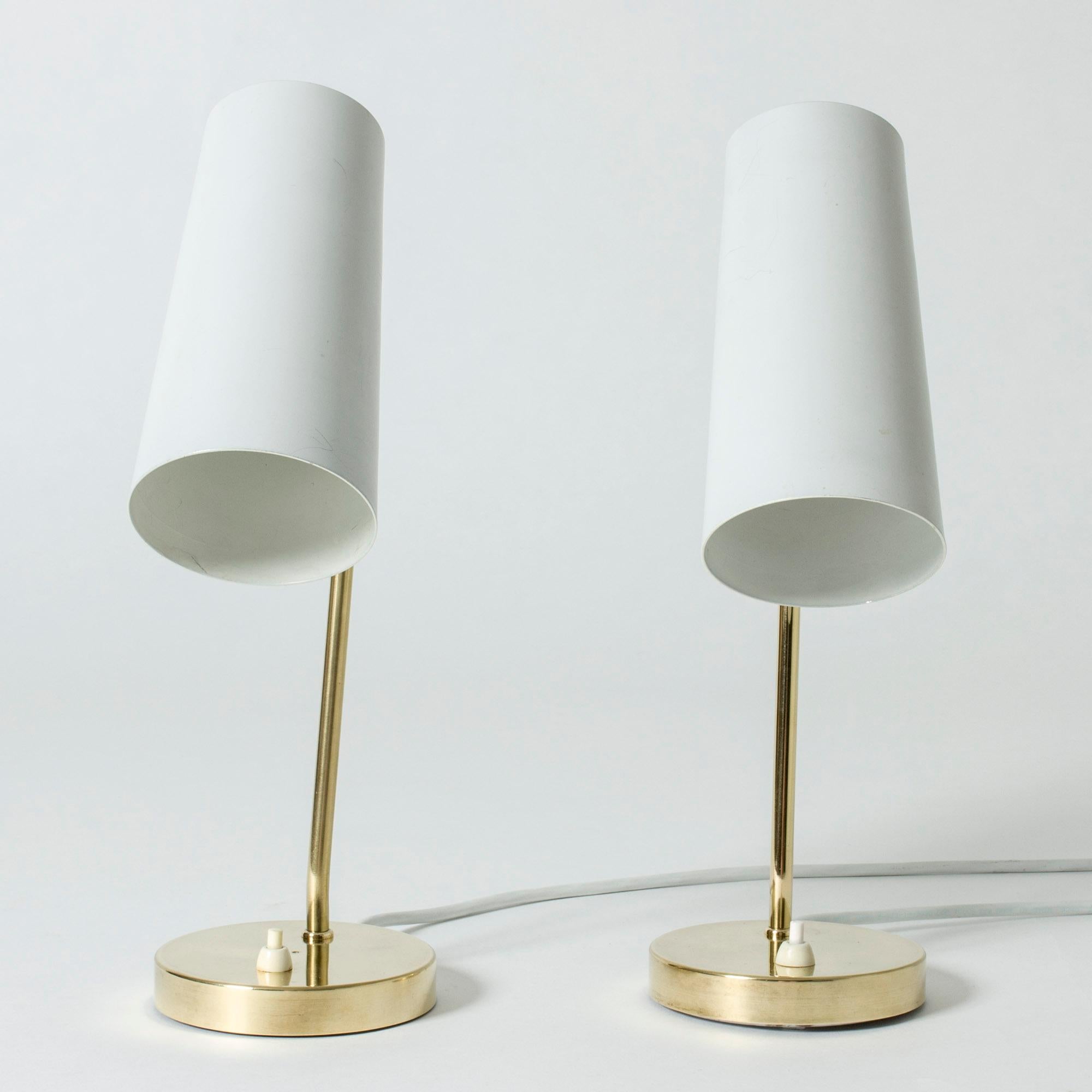 Pair of cool, sleek table lamps from Böhlmarks, made from brass with grey lacquered shades. Cylinder shaped shades that have wide holes at the top, letting out light elegantly.