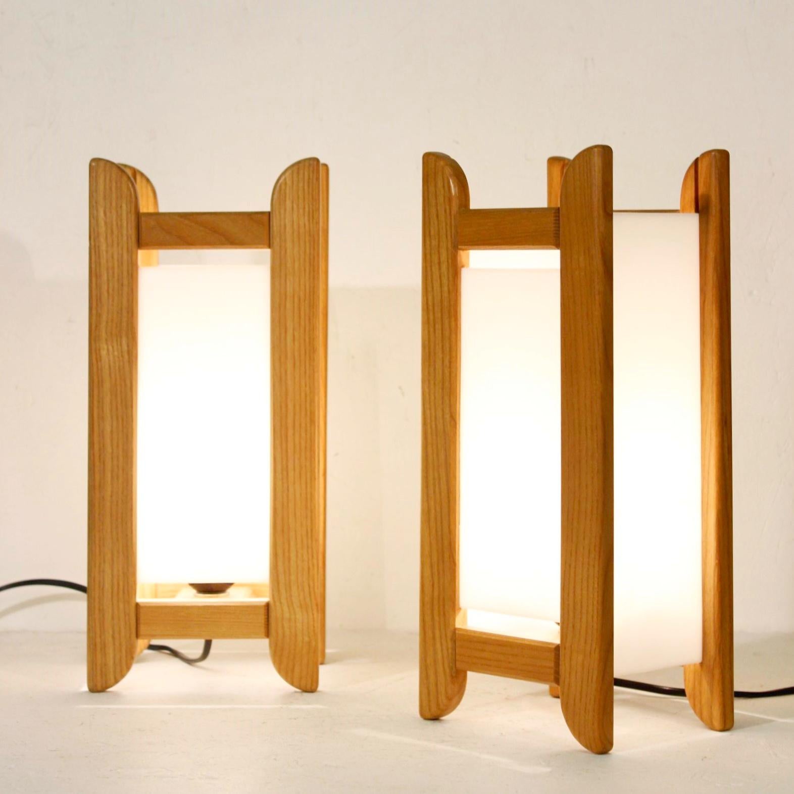 Pair of beech and white acrylic lamps circa 1980, signed by Alain Gaubert. 

Alain Gaubert was a French cabinetmaker popular for his meditation stool 