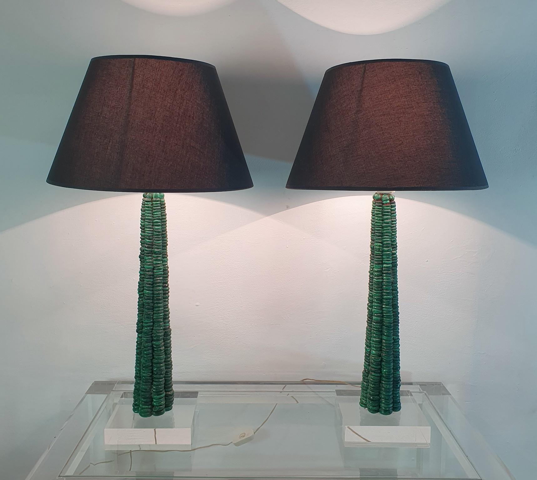A large pair of elegant table lamps with a clean and modern design. Hand made from malachite stone column which is standing on a square lucite base paired with new lampshades in black fabric.