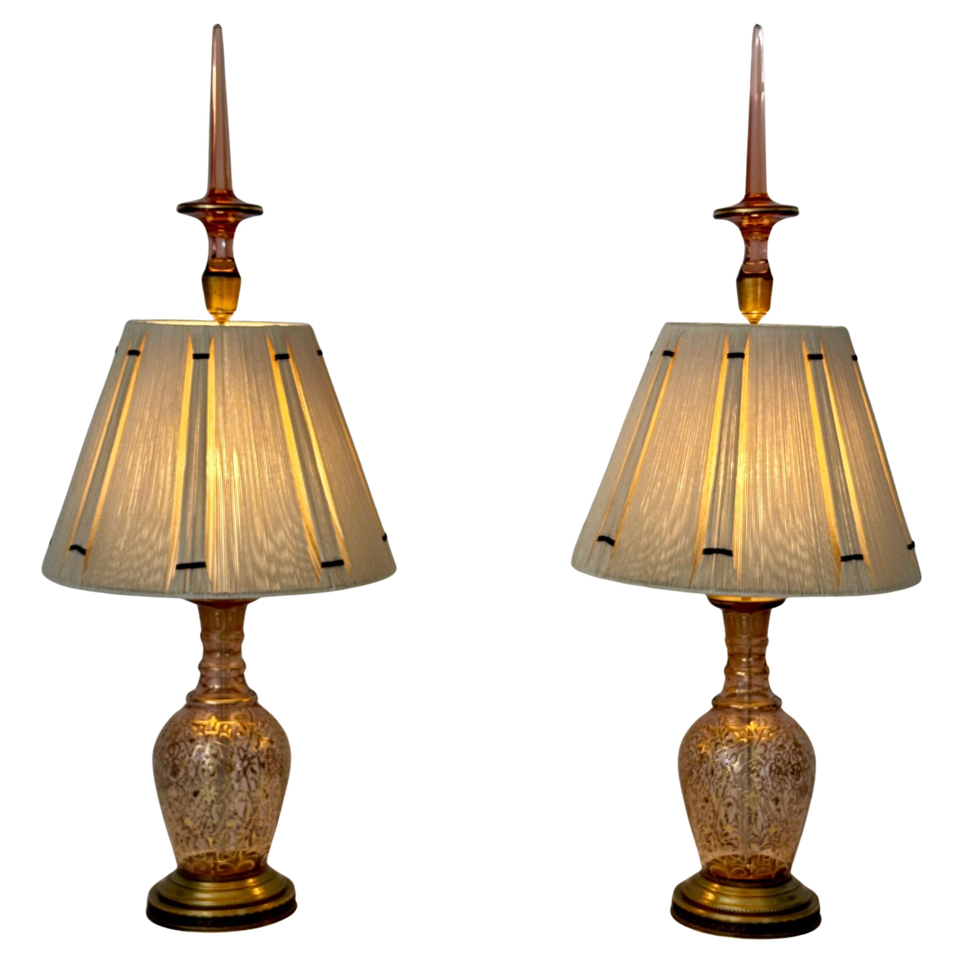 A striking and sculptural pair of table lamps crafted from richly detailed Moser glass Turkish decanters, featuring elaborate gold-accented floral etching and faceted stoppers (17