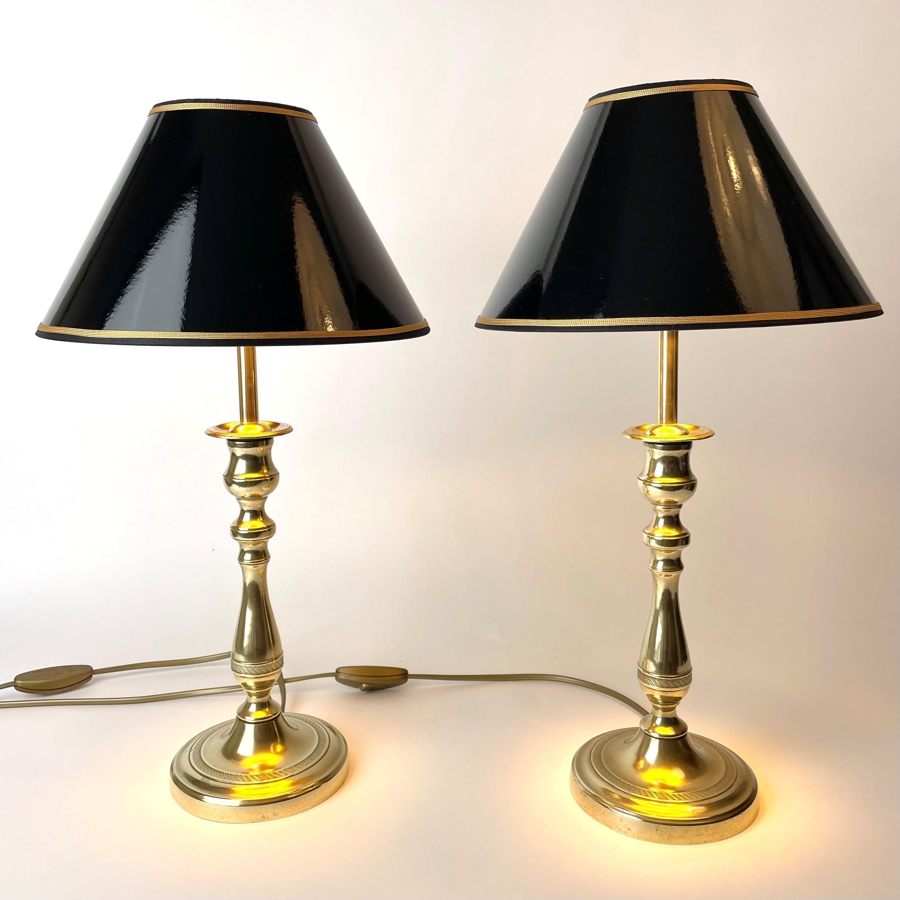 A pair of beautiful Table Lamps, originally Empire (Restauration, circa 1830) candlesticks in brass that have been converted into electric table lamps. New lampshades in black lacquer with gilding on the inside to give a cozy impression.

The