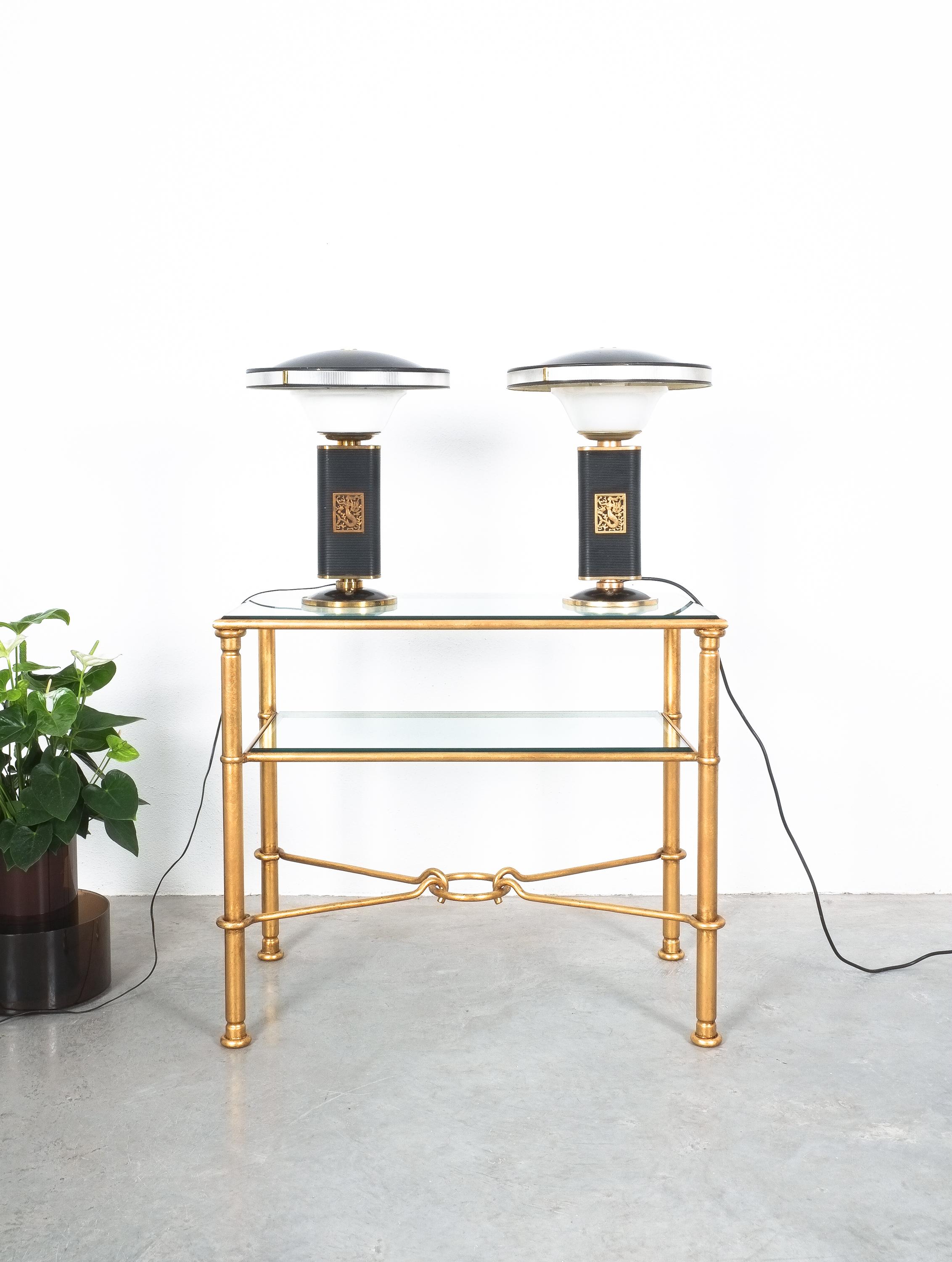 Pair of mermaid table lights by Eileen Gray for Jumo, circa 1945 

Exceptional pair of French table lamps 'Sirene' by Eileen Gray edited by Jumo. This iconic lamp is constructed in black lacquered folded sheet metal resting on a circular brass and