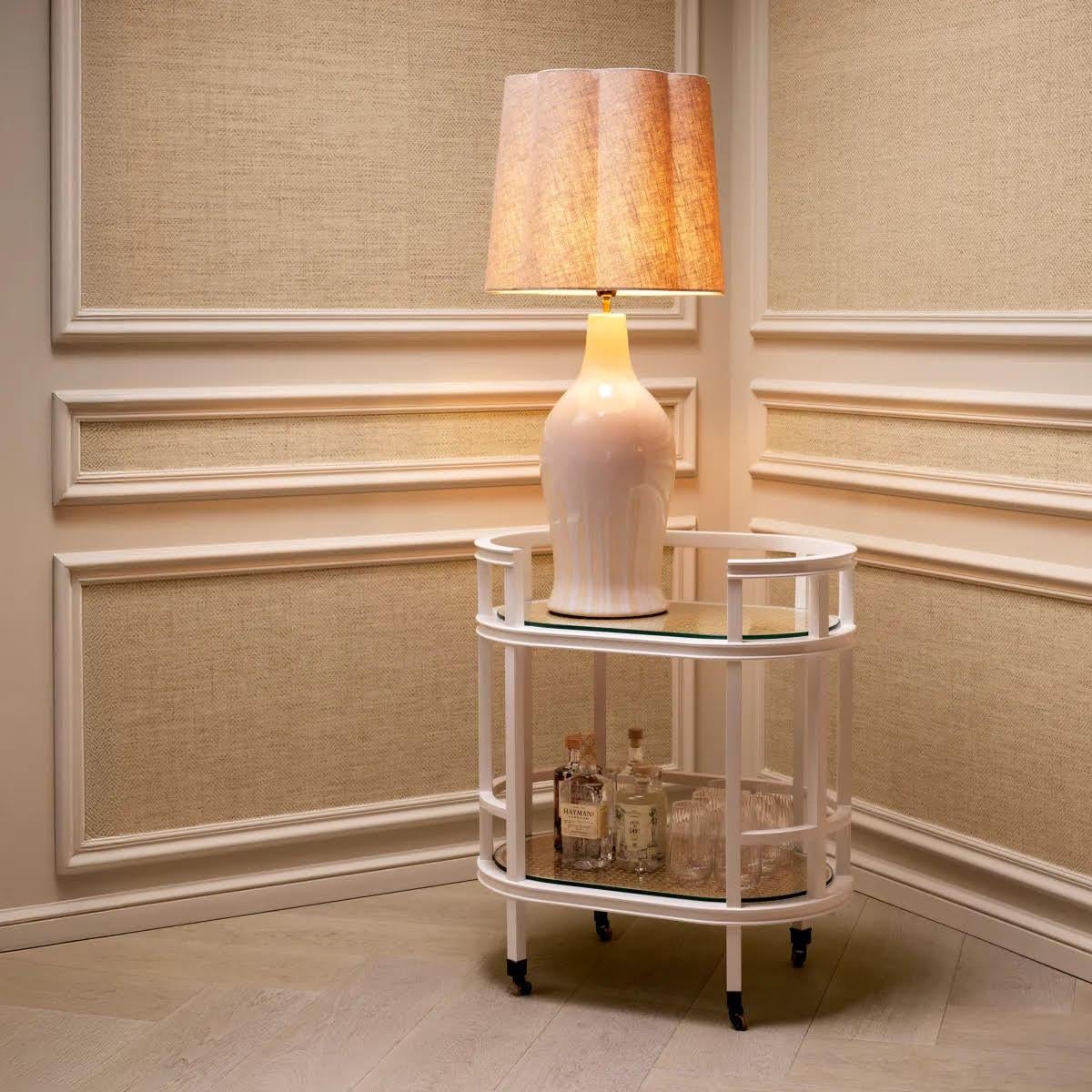 Choose refinement with this table lamp, featuring a white ceramic base with a distinctive drop effect, enhanced with a touch of vintage brass.
This unique piece has a specially designed linen blend lampshade, giving it incomparable charm and