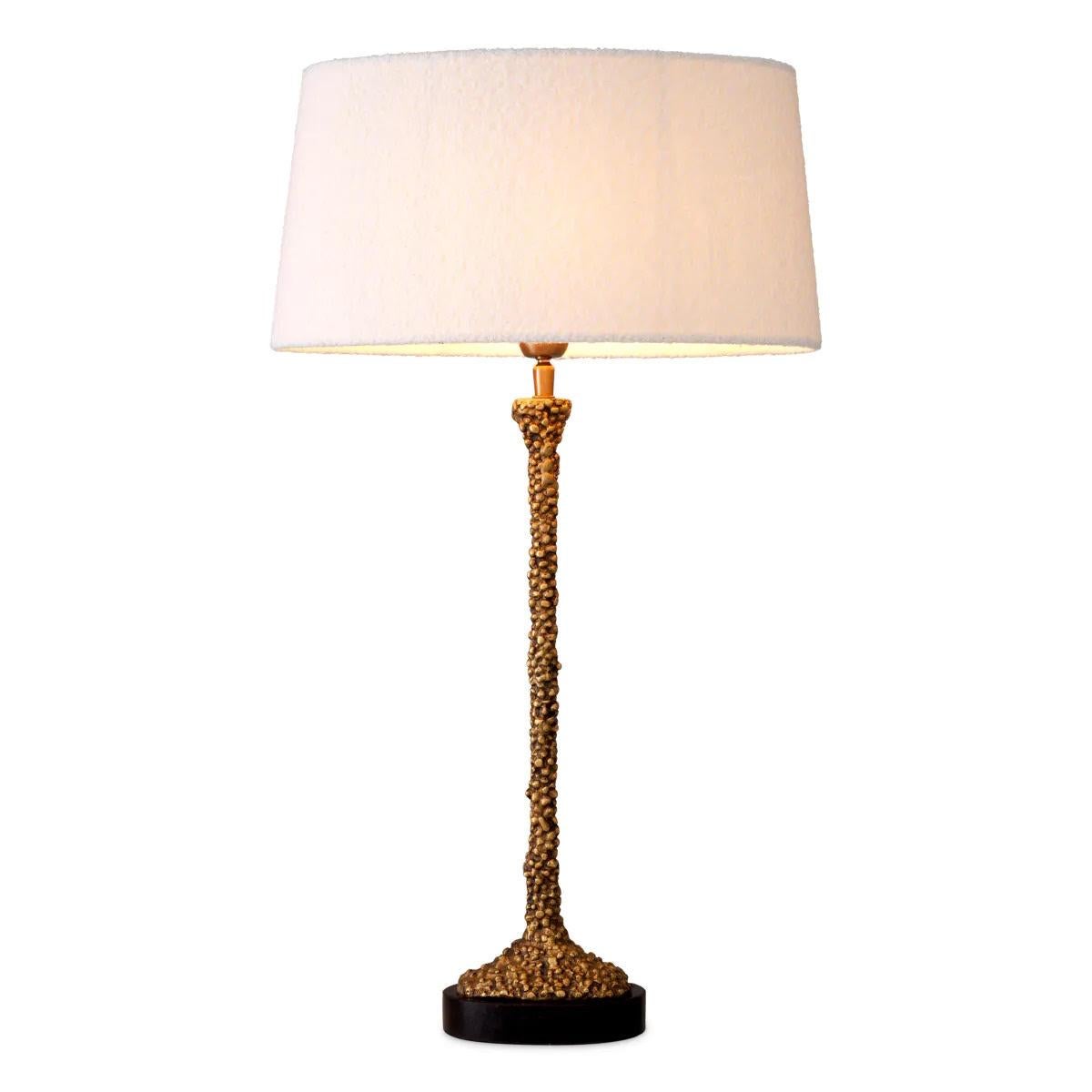 Pair of table lamps, with a patinated brass finish and black granite base, offering beautiful quality and sophisticated style.

This pair of table lamps with a patinated brass finish and black granite base is very elegant, and its curled lampshade