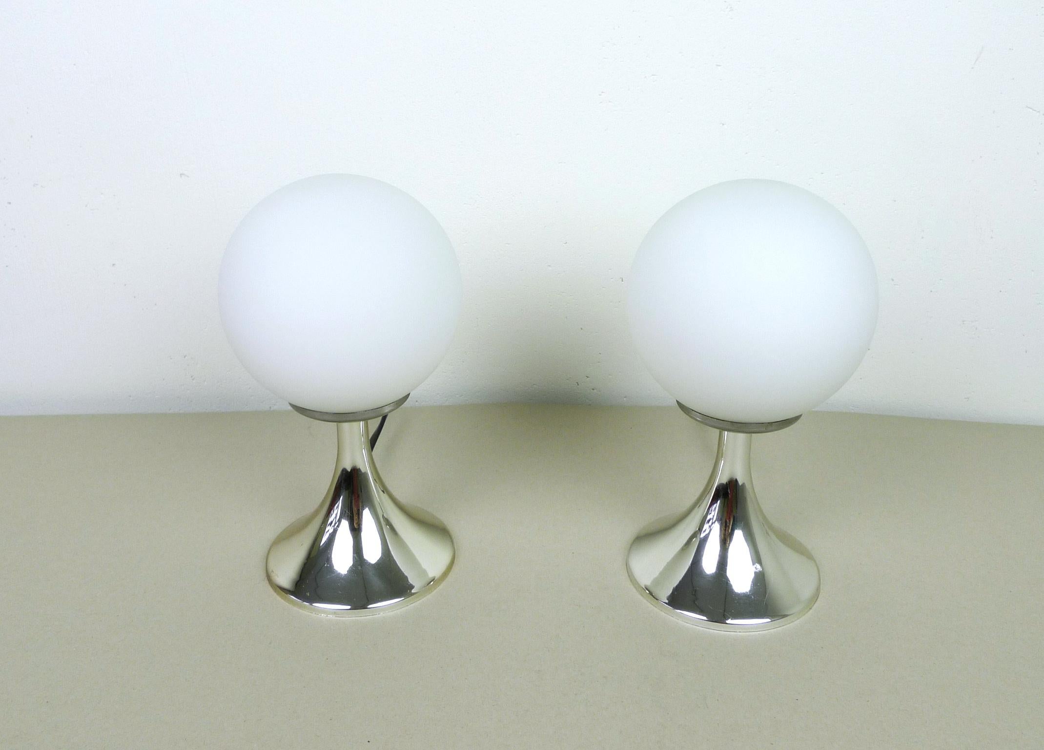 Pair of table lamps with white opal glass globes and chromed tulip bases made of plastic. Each one has a E 14 bulb socket inside. They were produced in Germany in the 1960s and they are in good condition.