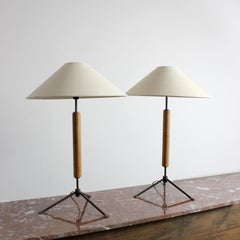 Pair of table lamps with wrought iron frames, tripod bases, and wooden stems